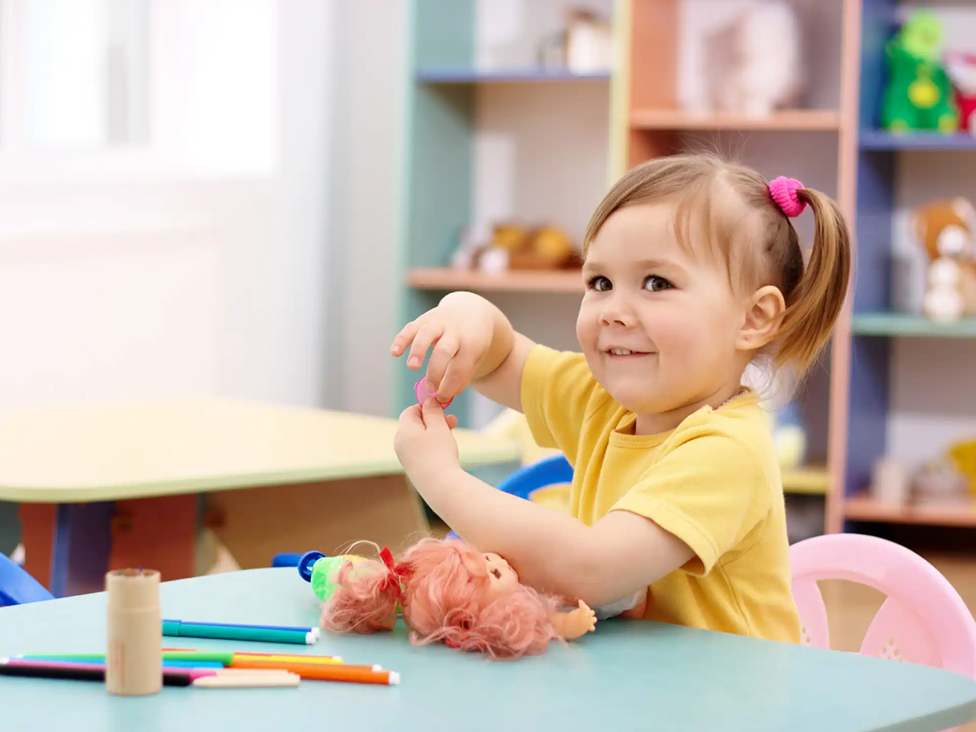 a little girl sitting at a table