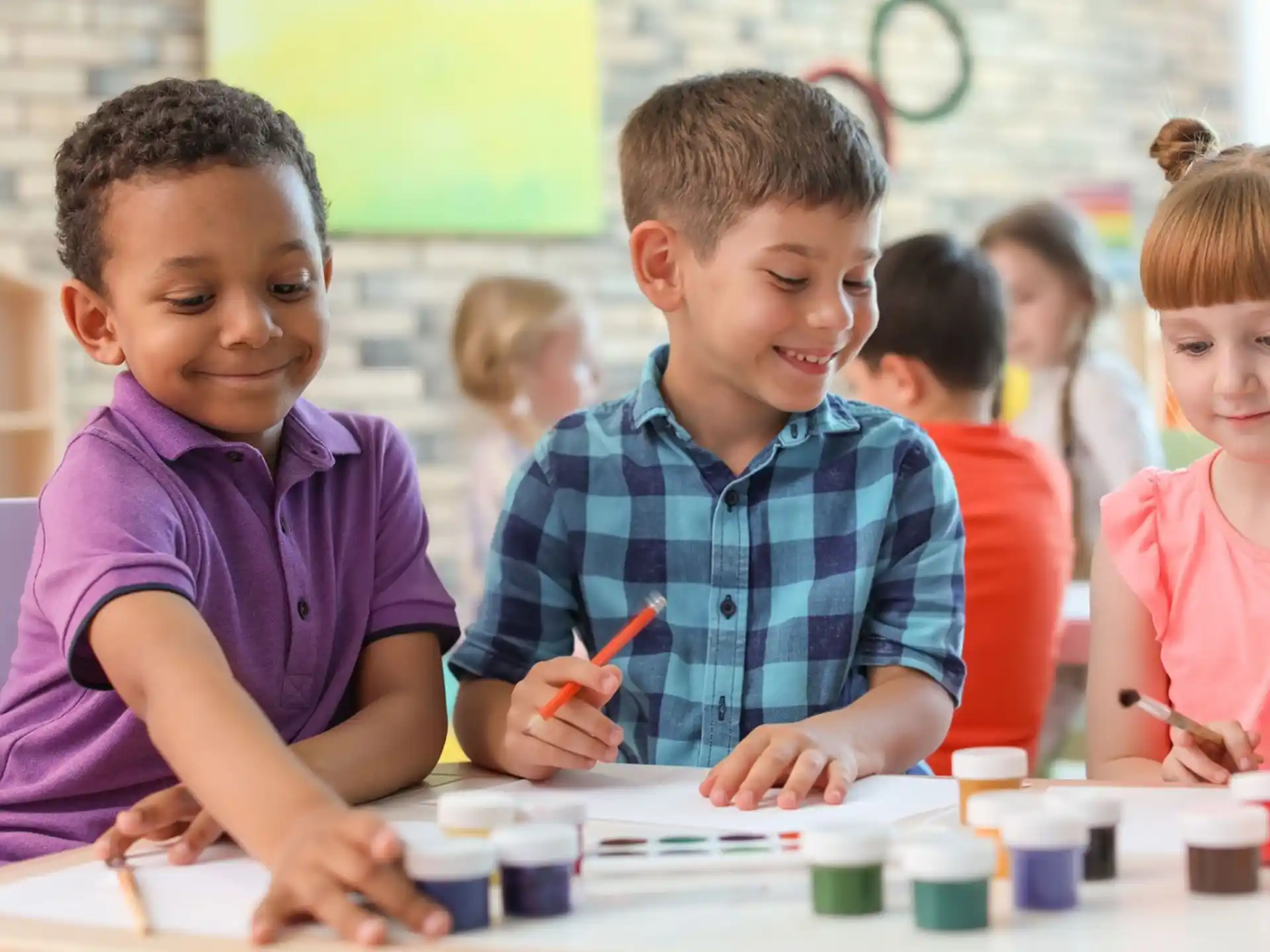 a group of children sitting at a table