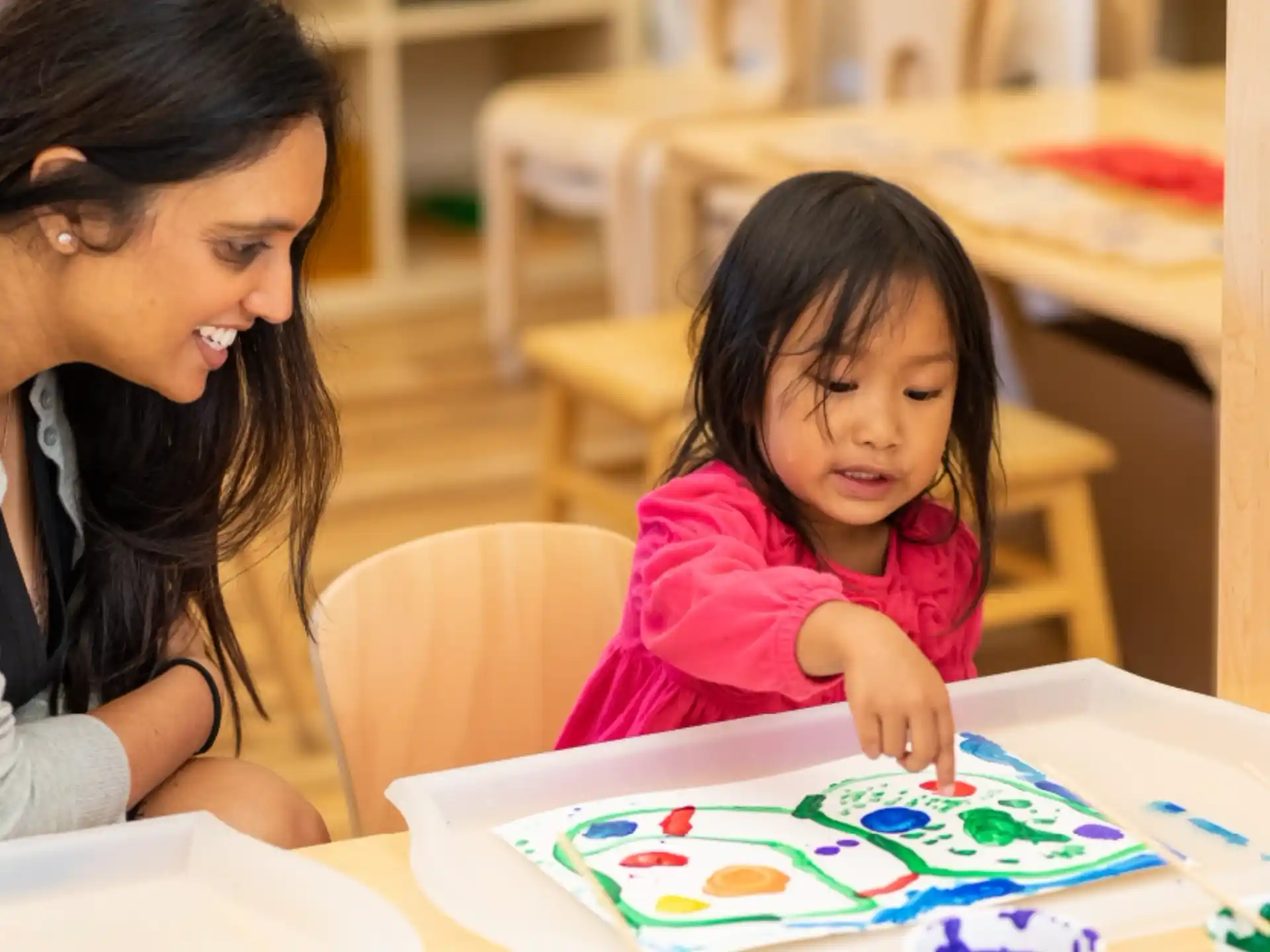 a person and a child painting