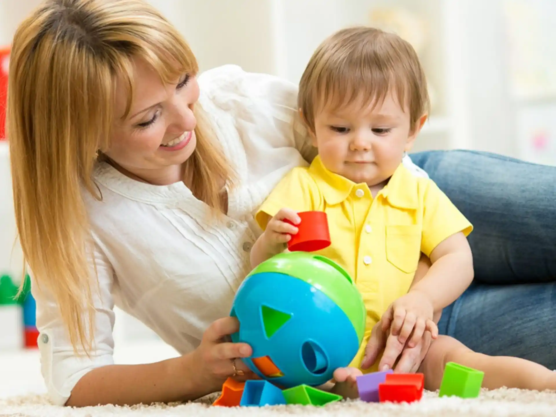 a person and a child playing with toys