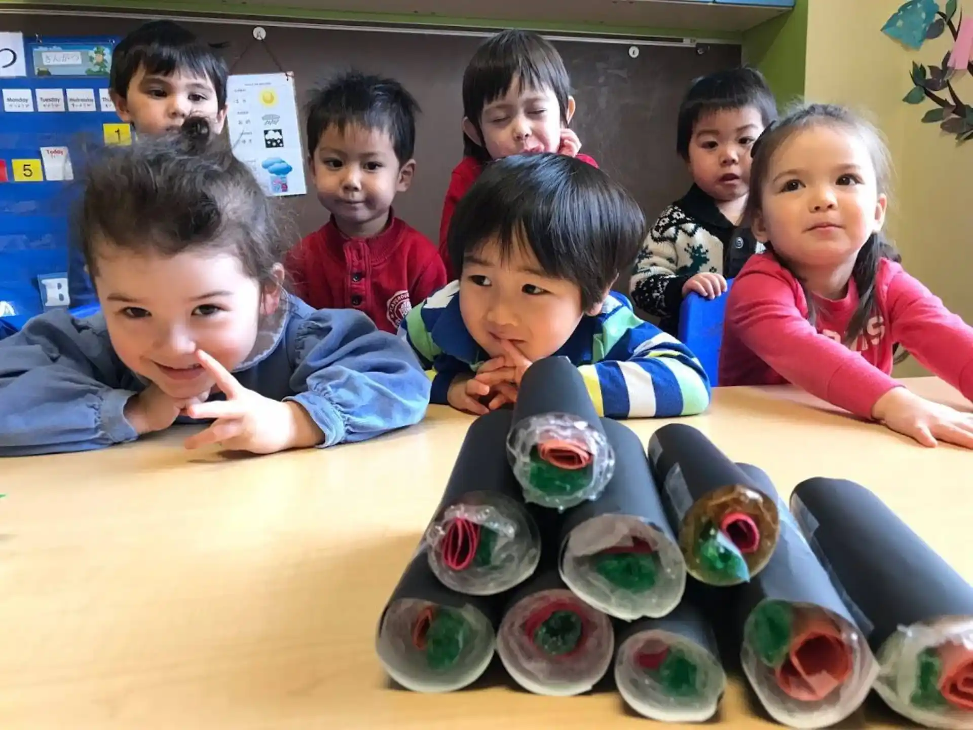 a group of children sitting at a table