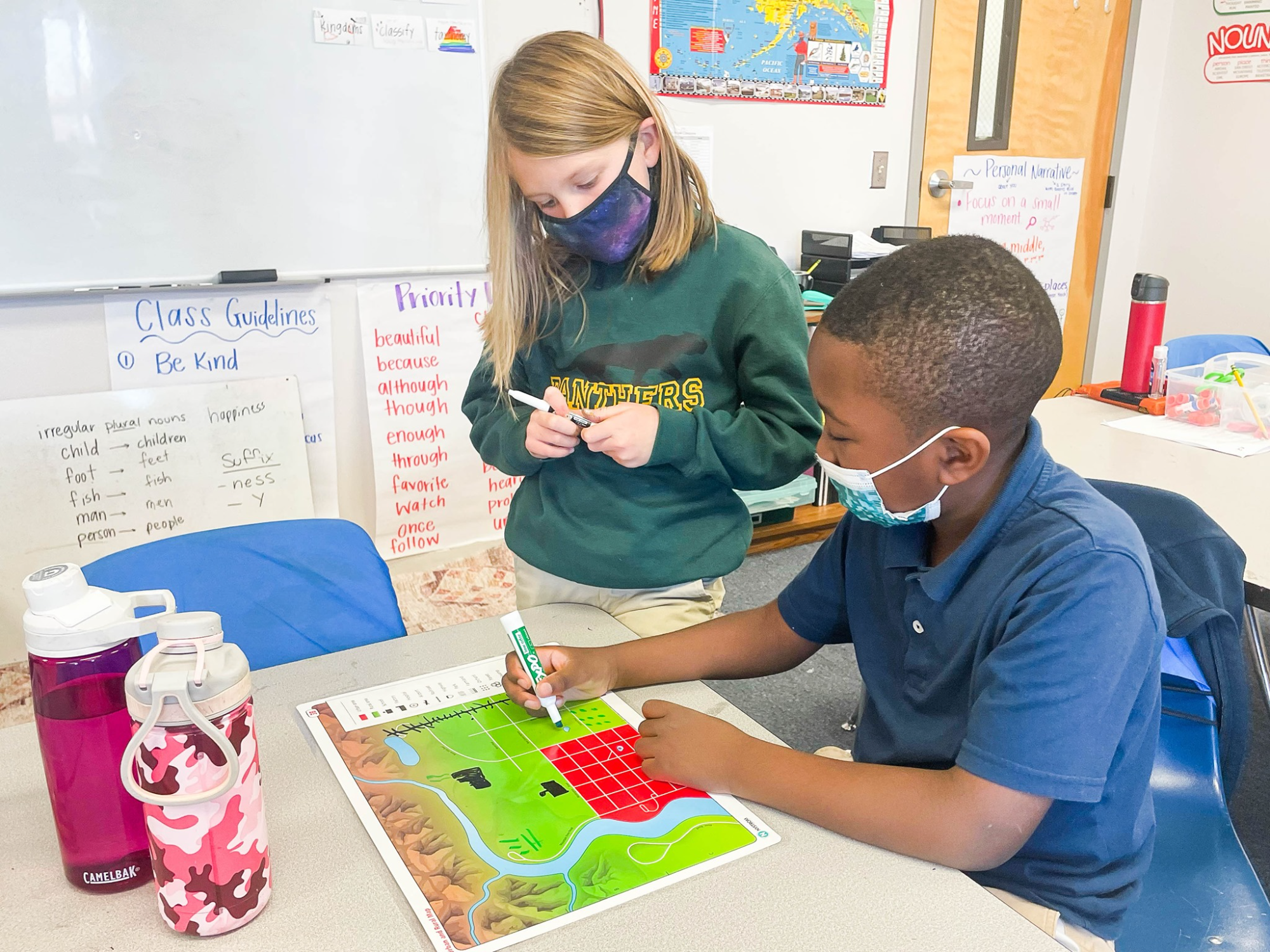 a teacher showing a student something on a book