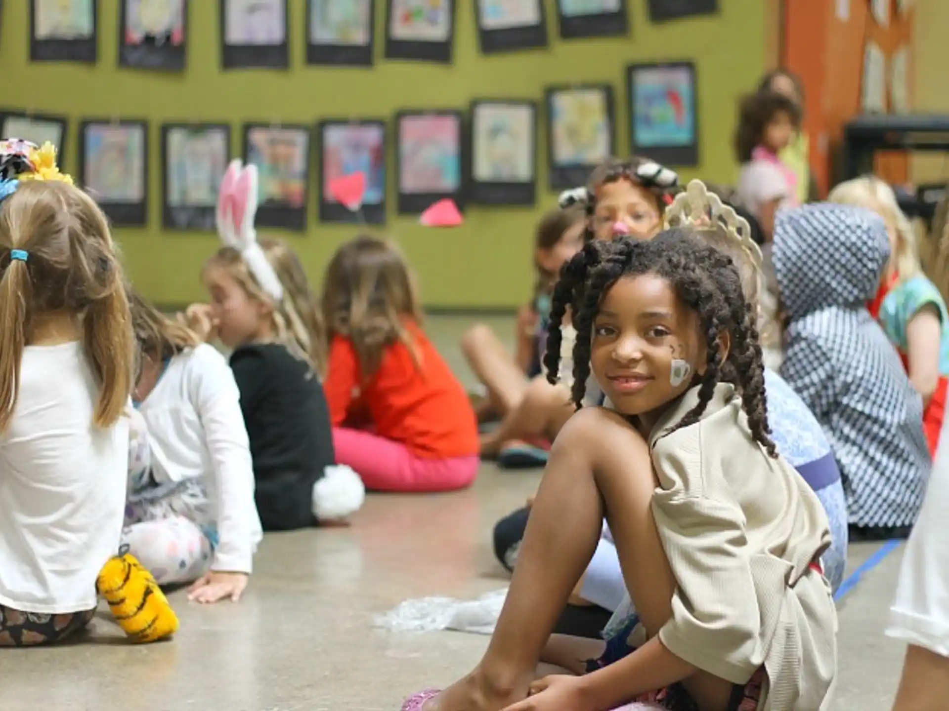 a group of girls sitting on the floor