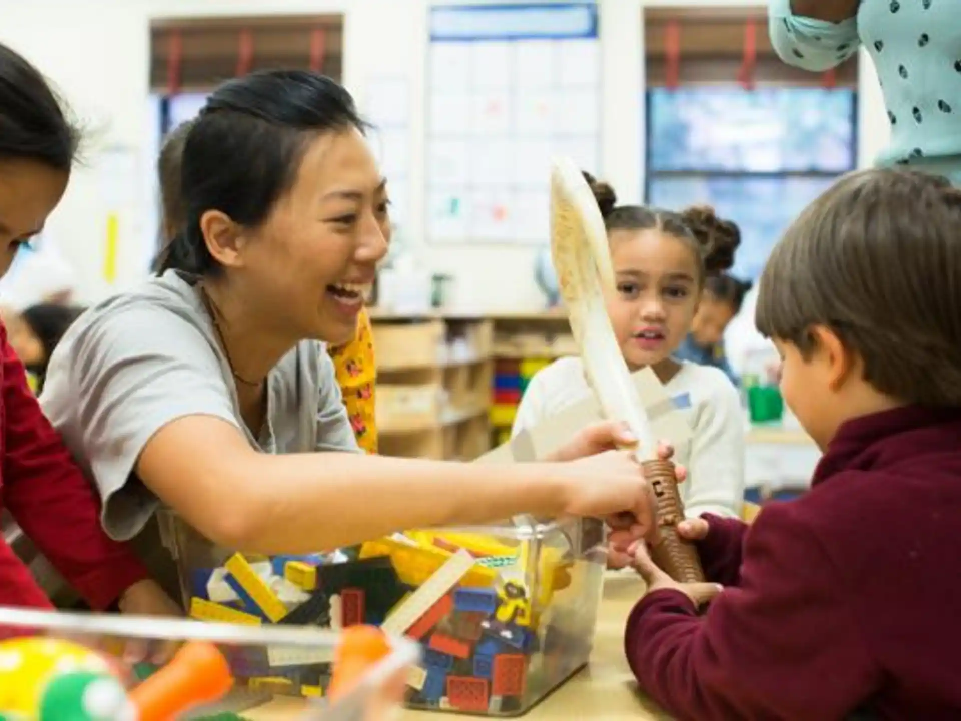 a person and children playing with toys