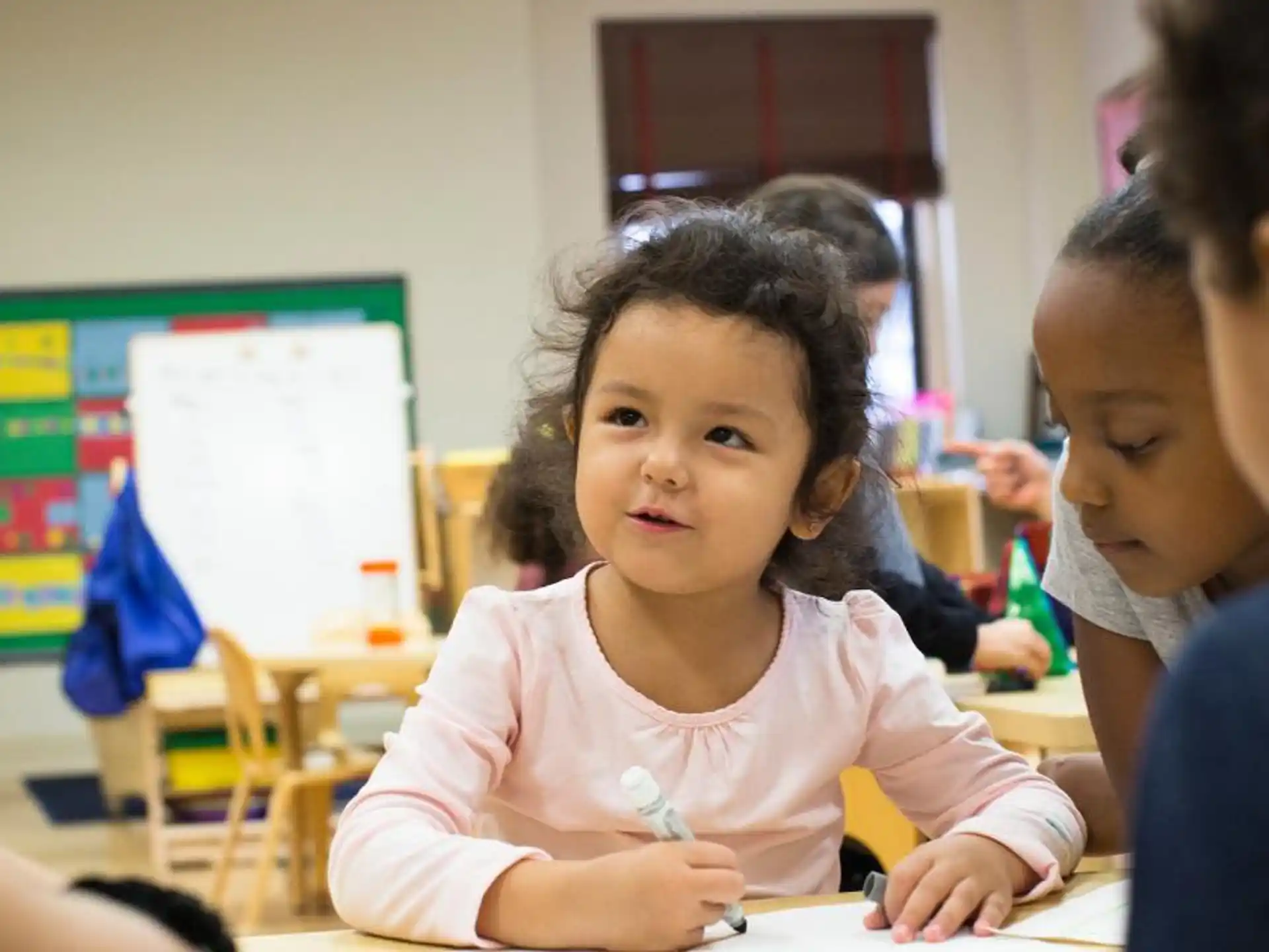 a young girl writing on a paper