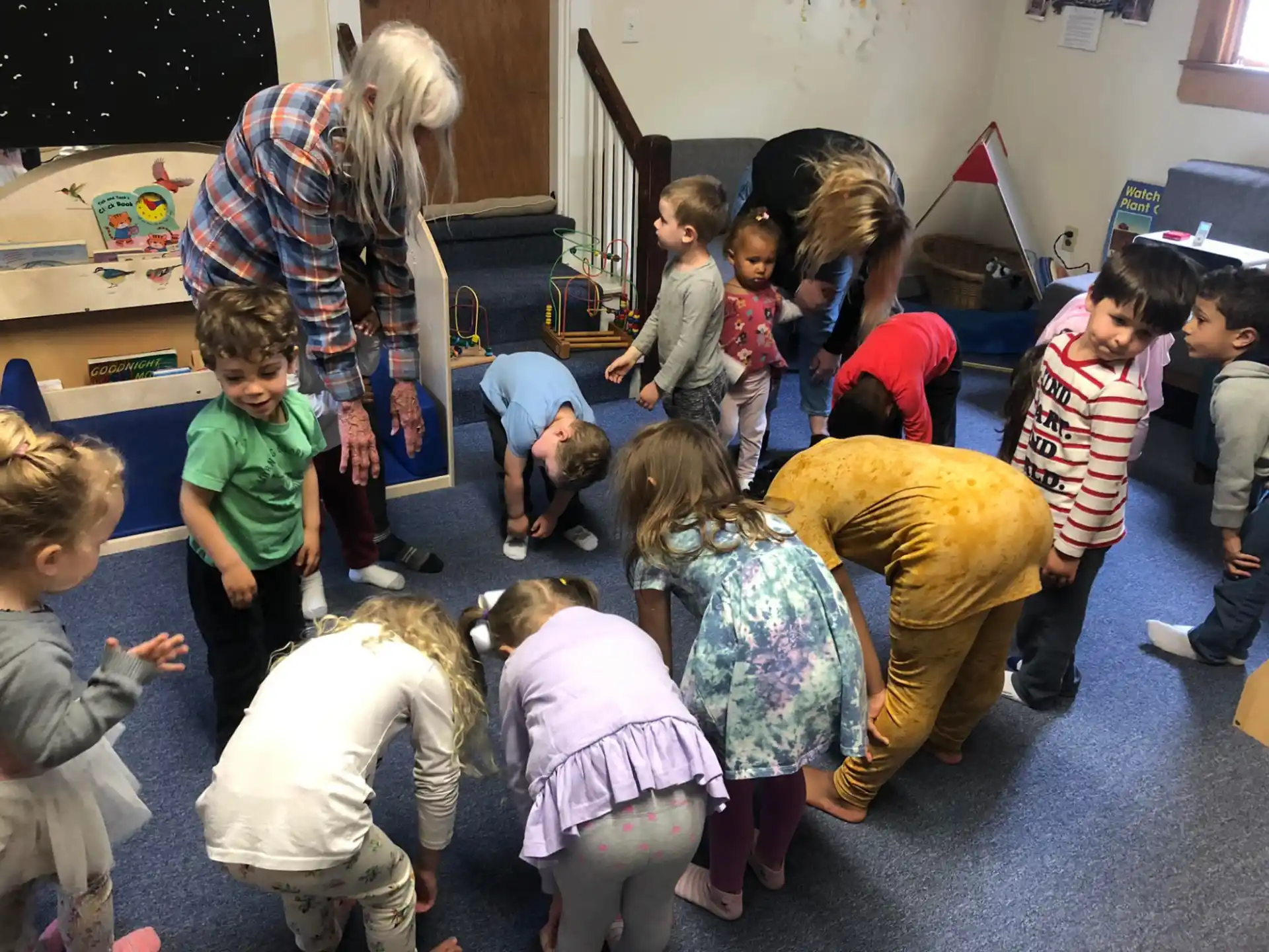 a group of children playing with a person