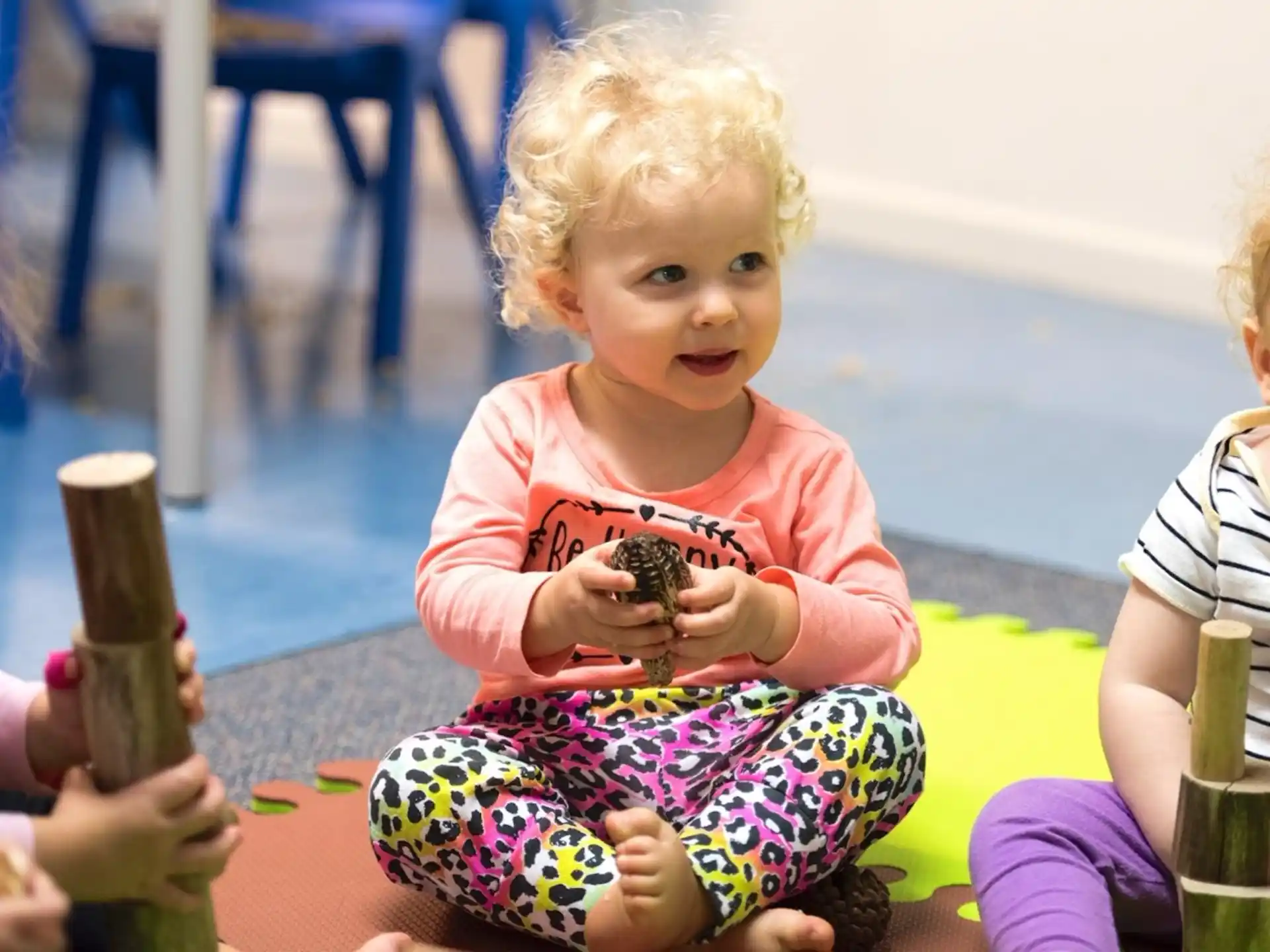 a baby holding a toy