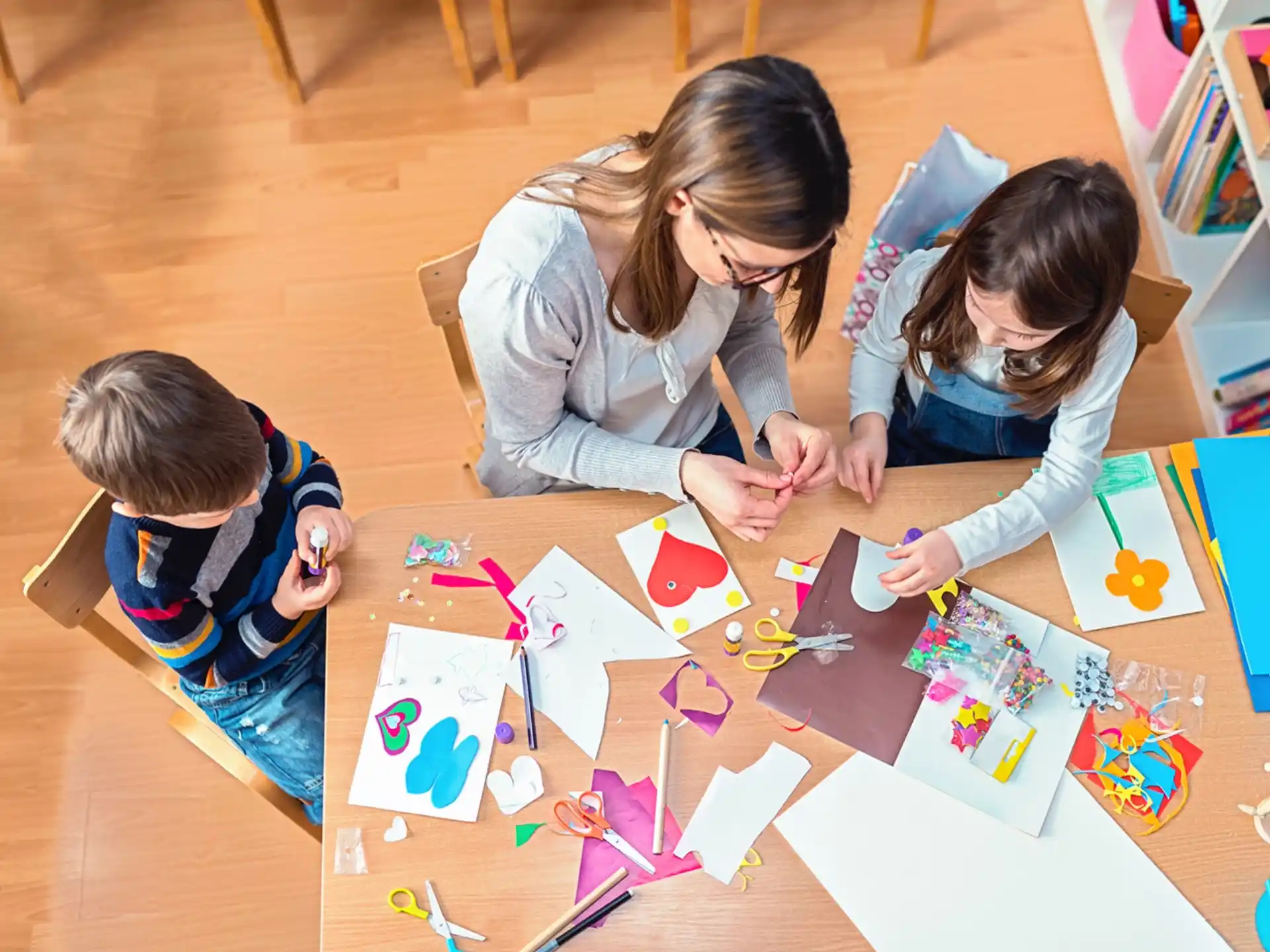 a person and a child coloring on paper