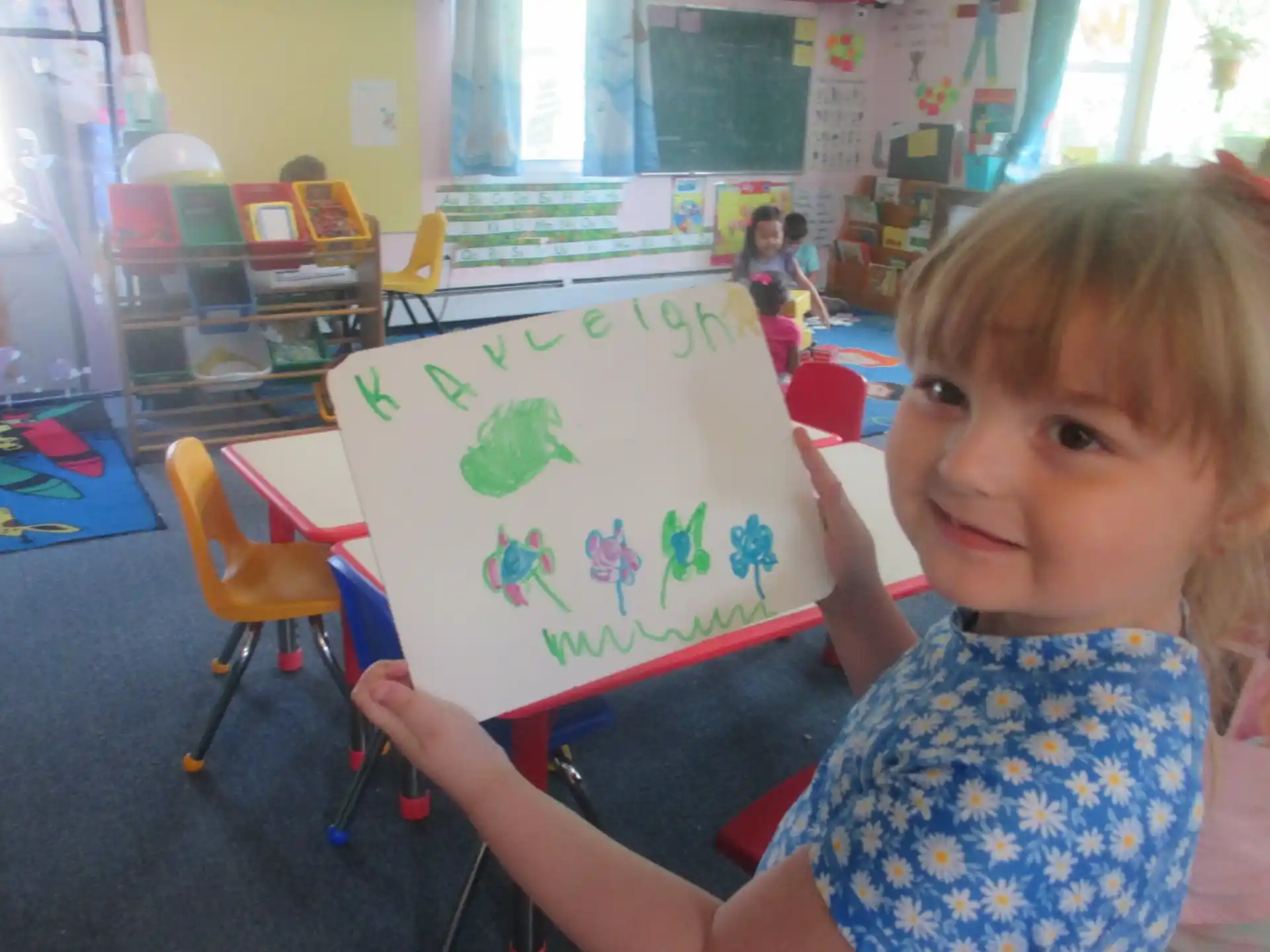 a child holding a drawing