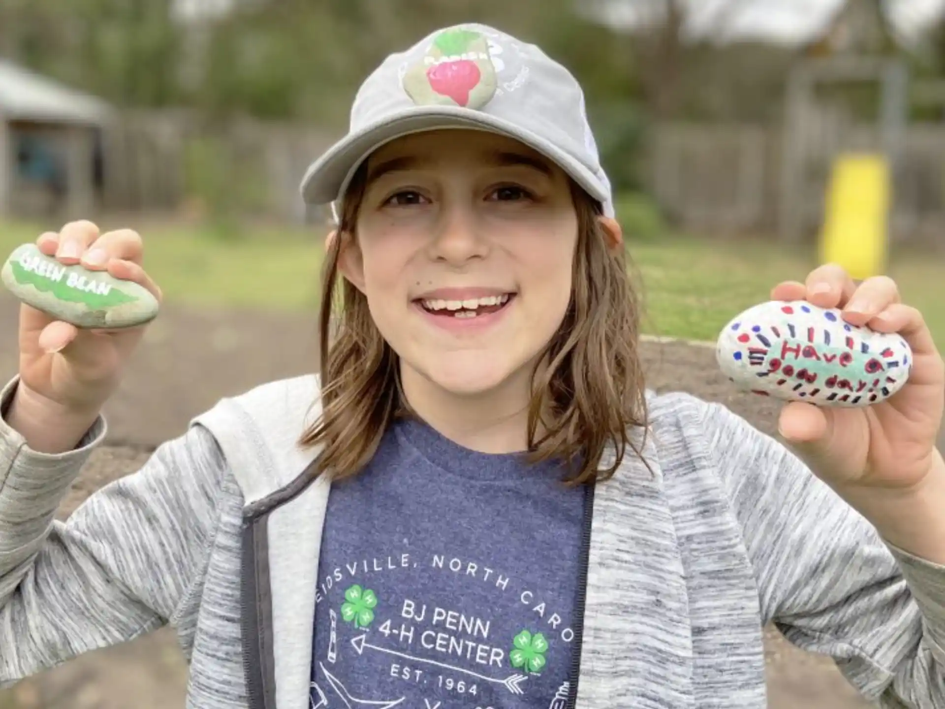 a girl holding a small cupcake