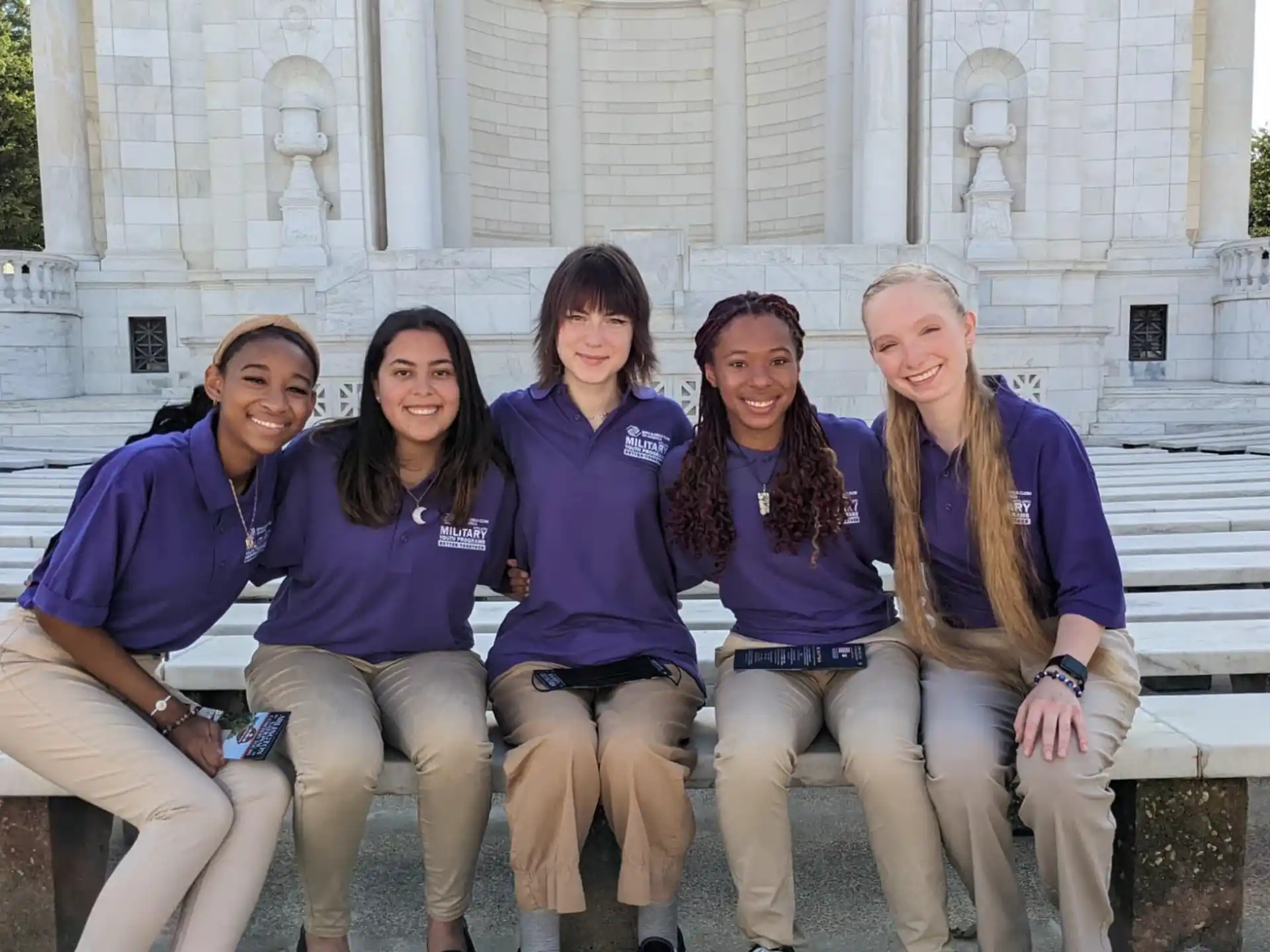 a group of women sitting on a bench