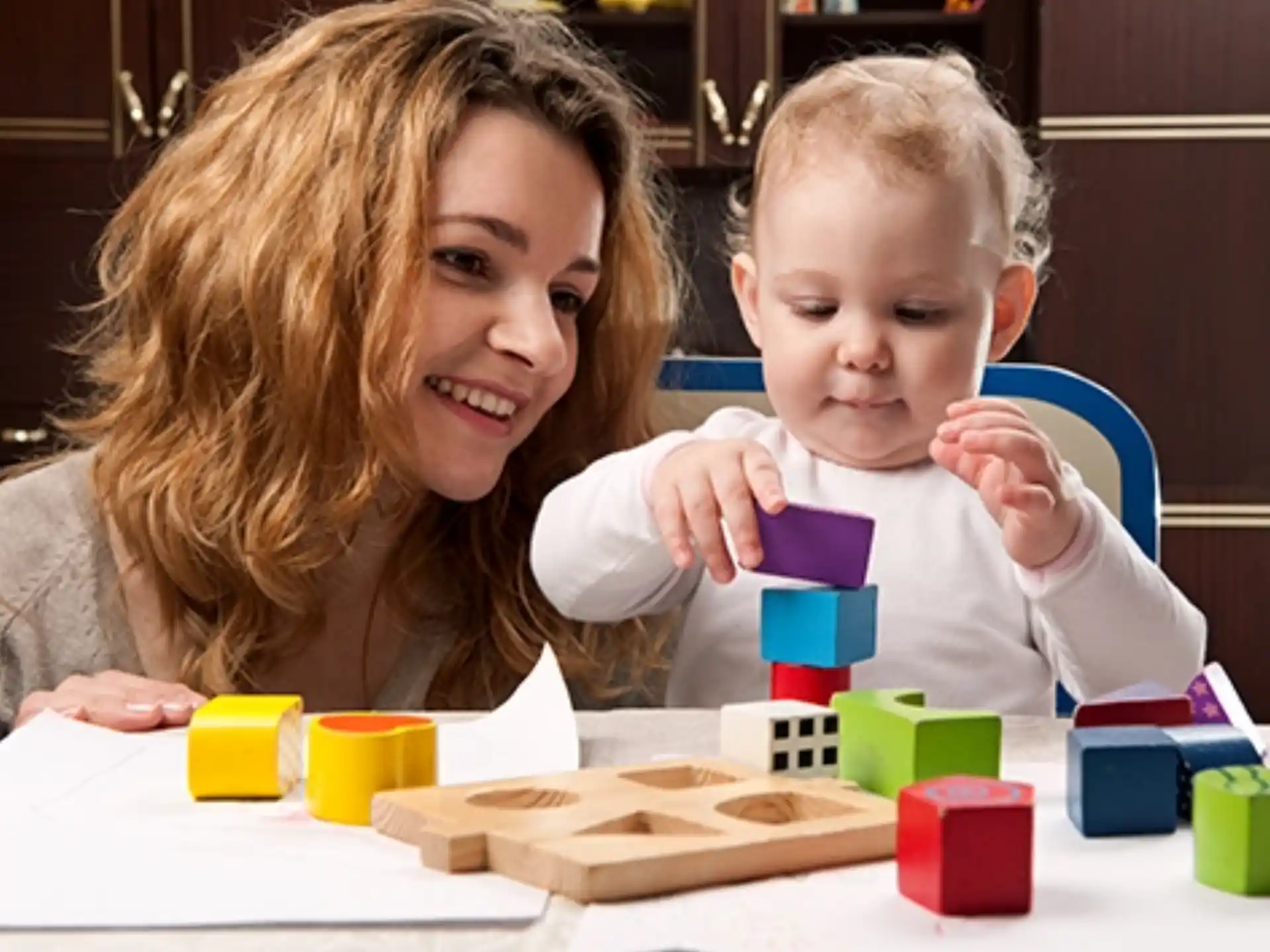 a person and a child playing with toys