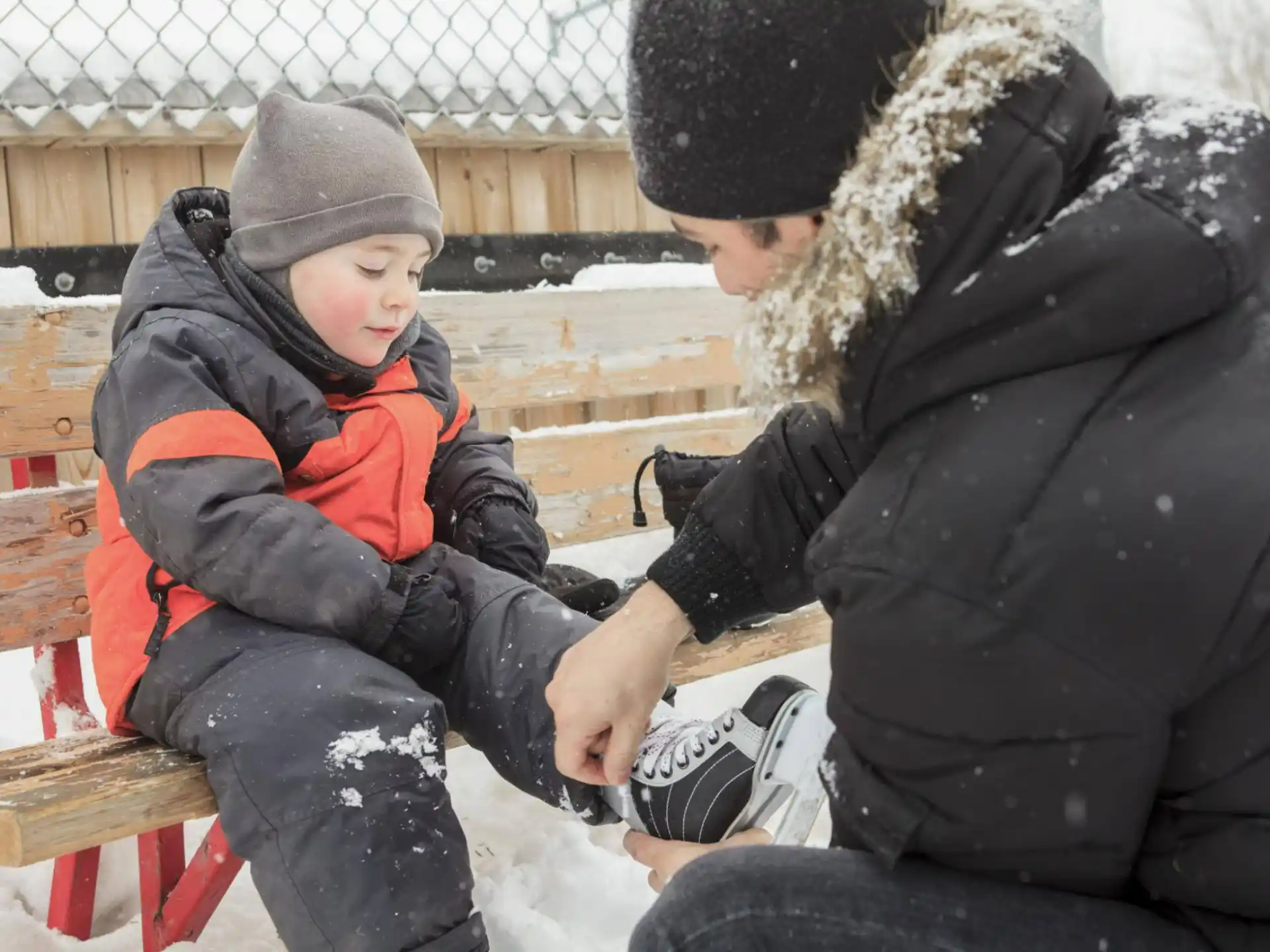 a person and a child playing in the snow