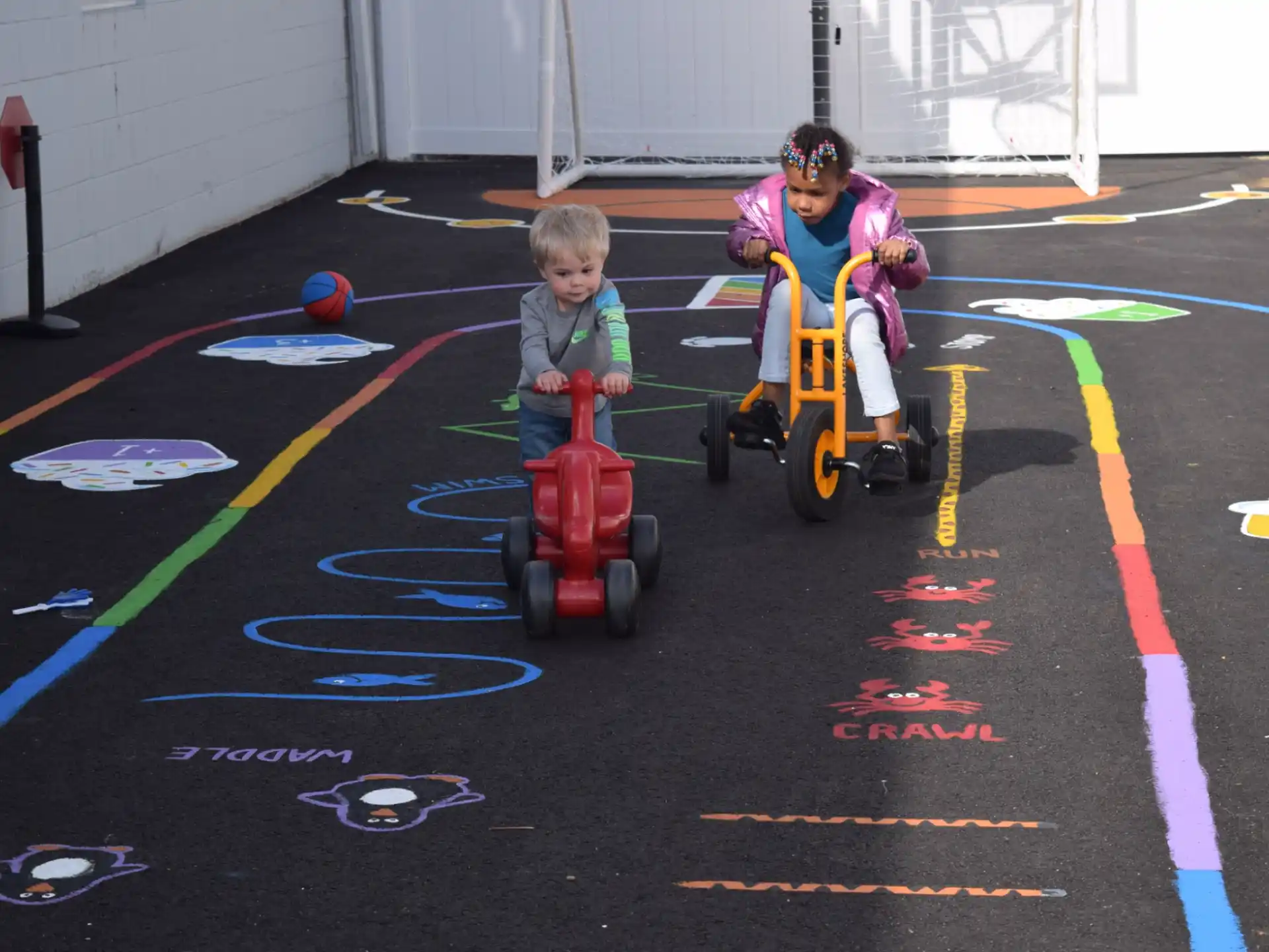 two kids riding toy vehicles