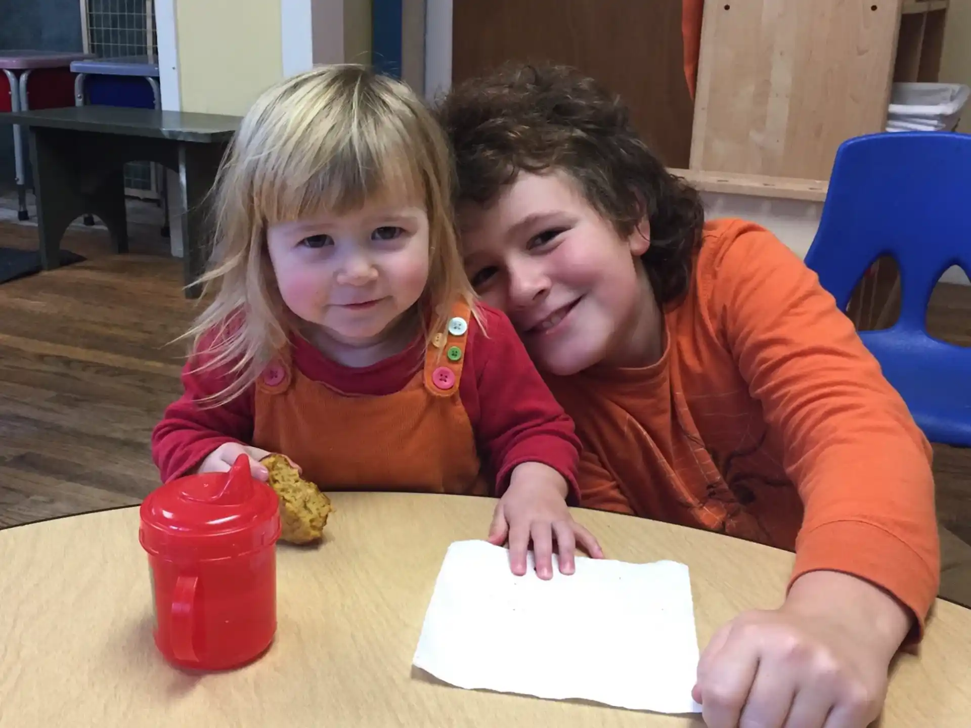 a person and a girl sitting at a table