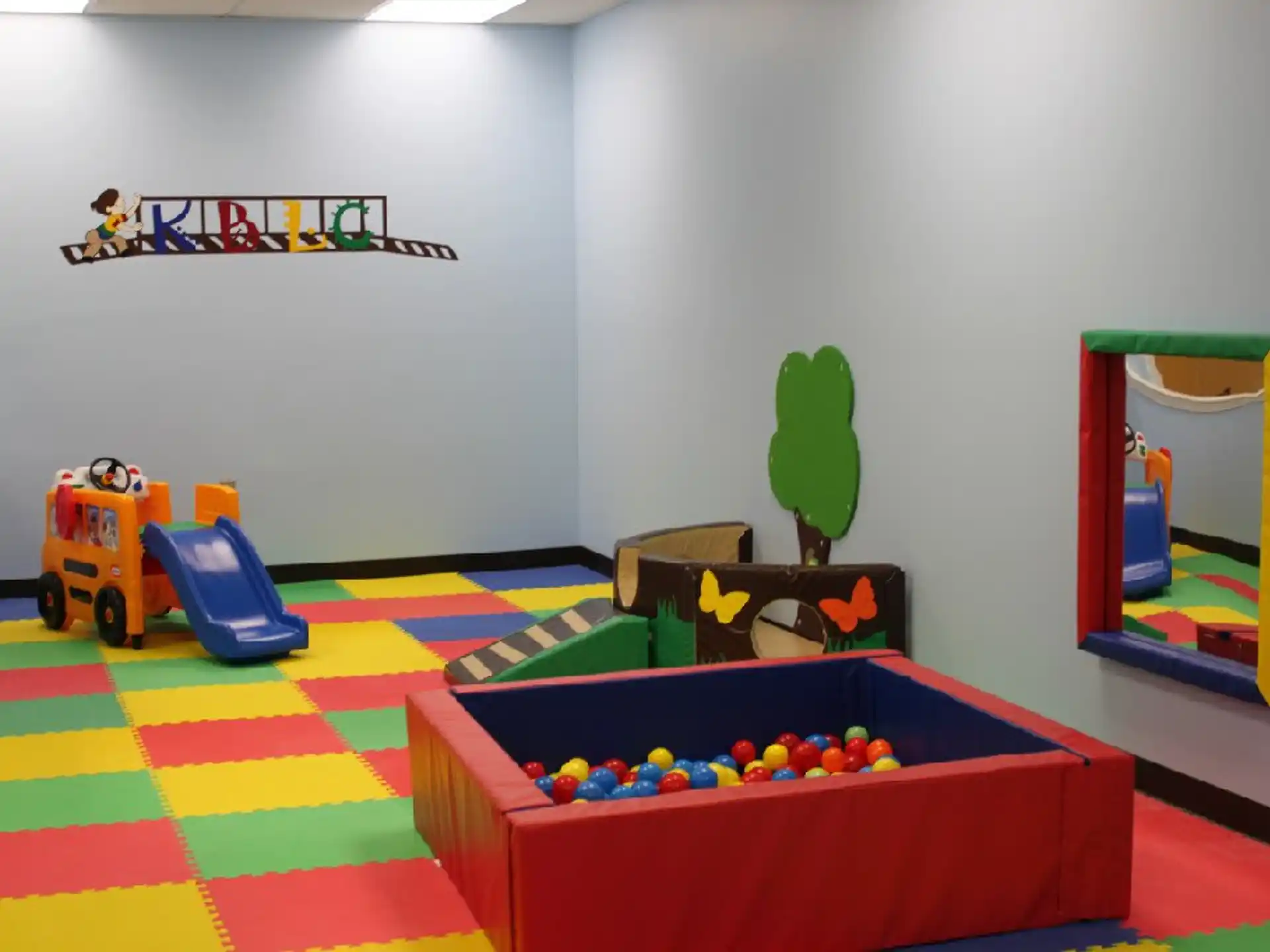 a room with toys and a play set