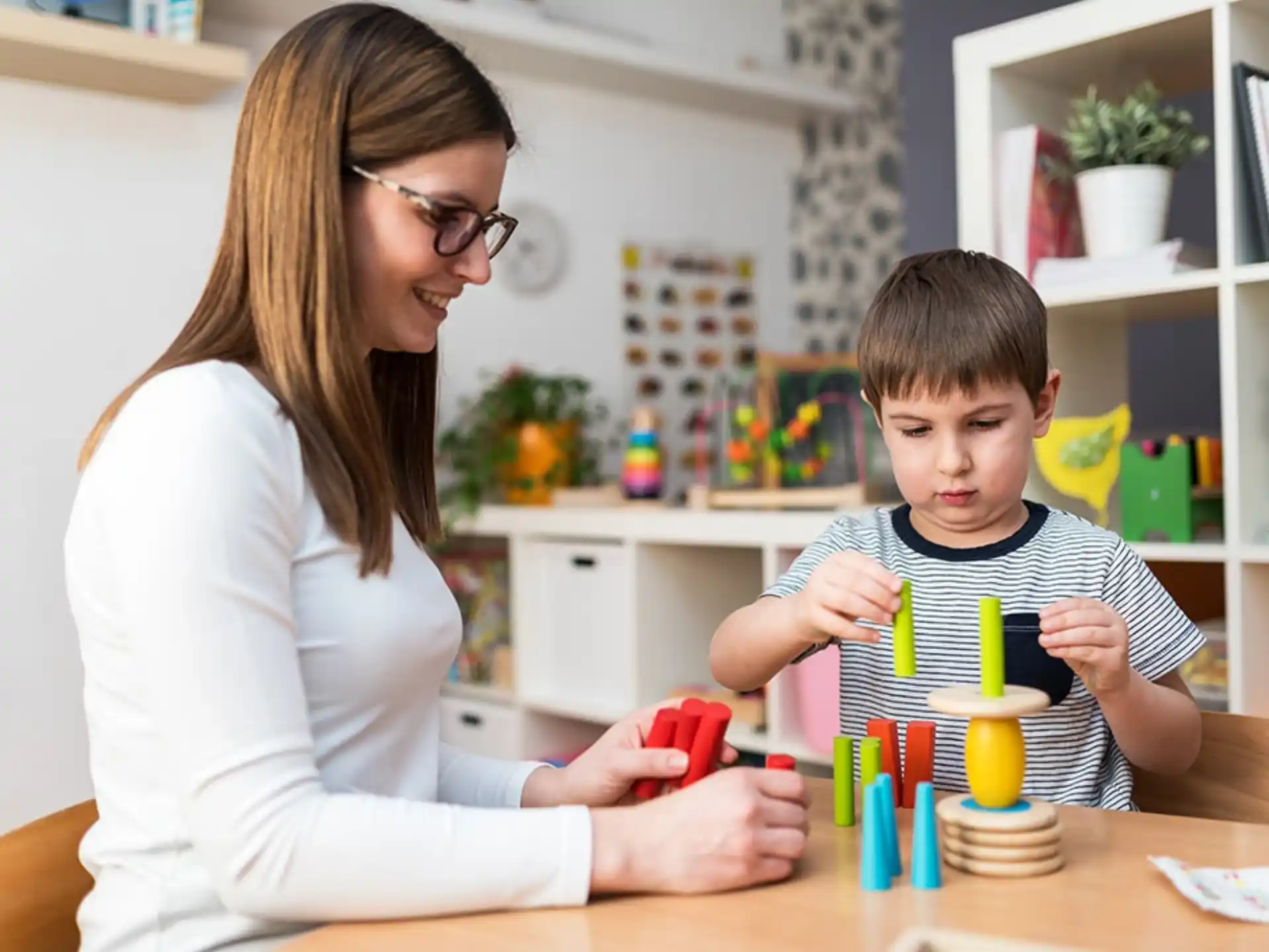 a woman and a boy playing with toys