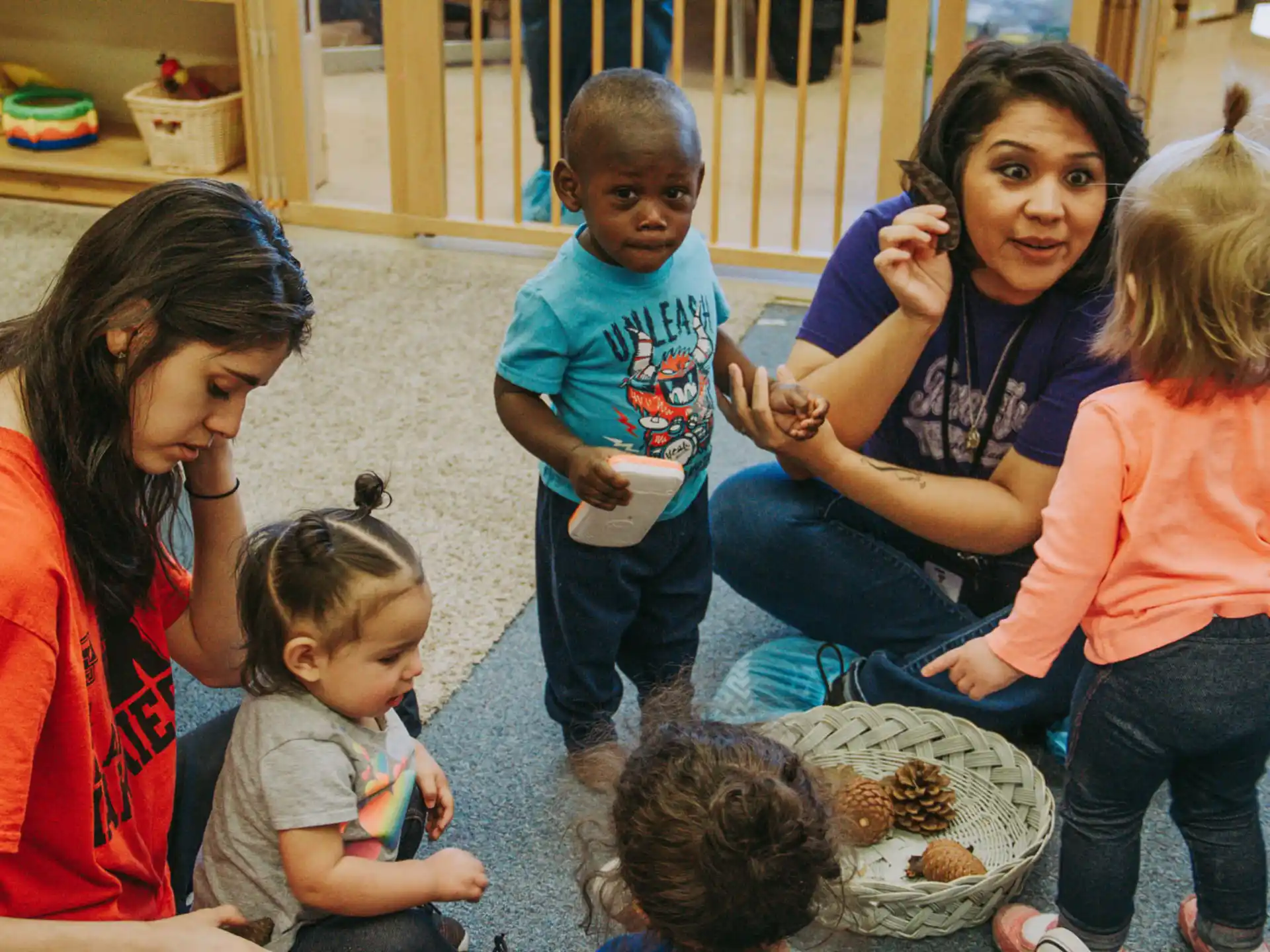 a group of children playing with a baby