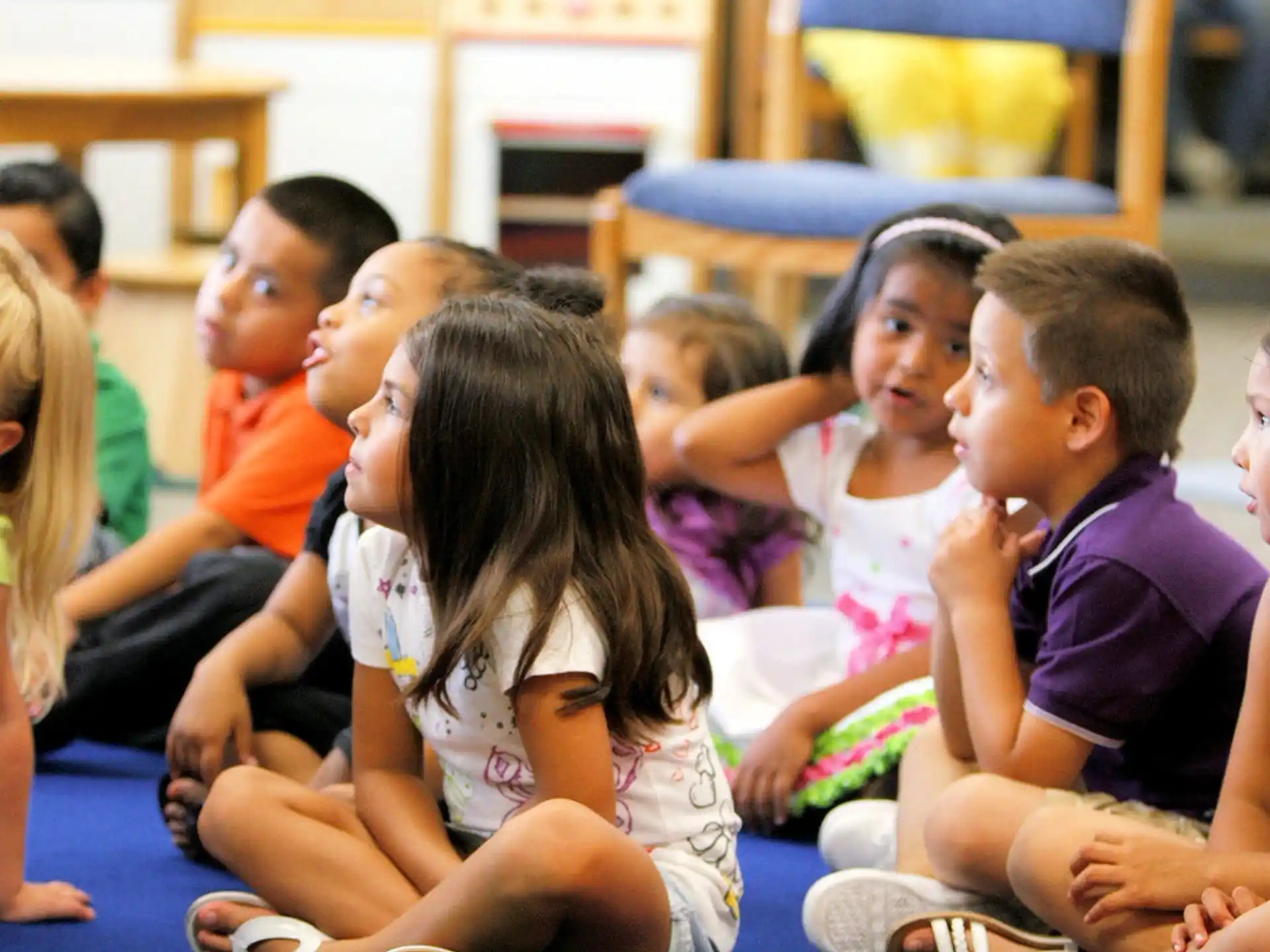 a group of children sitting on the floor
