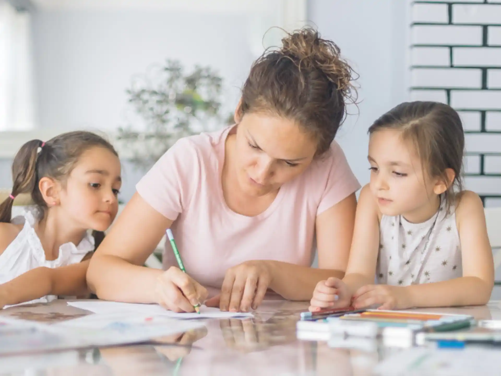 a person and two children sitting at a table