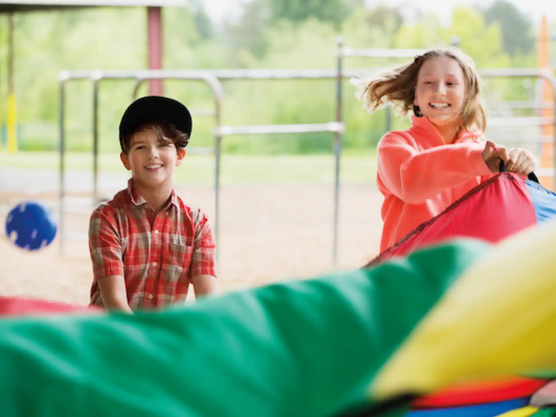 a boy and girl on a playground
