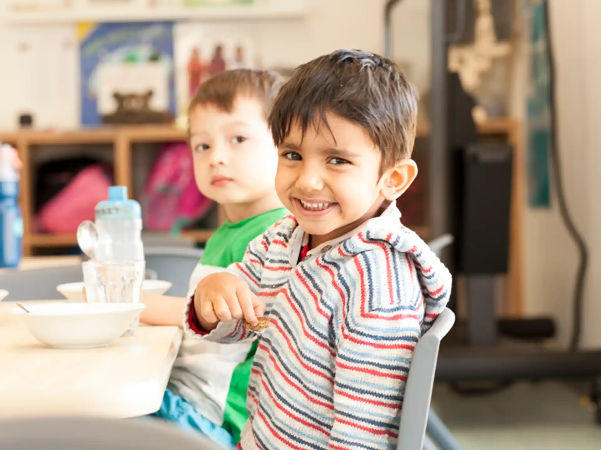 a couple of boys sitting at a table