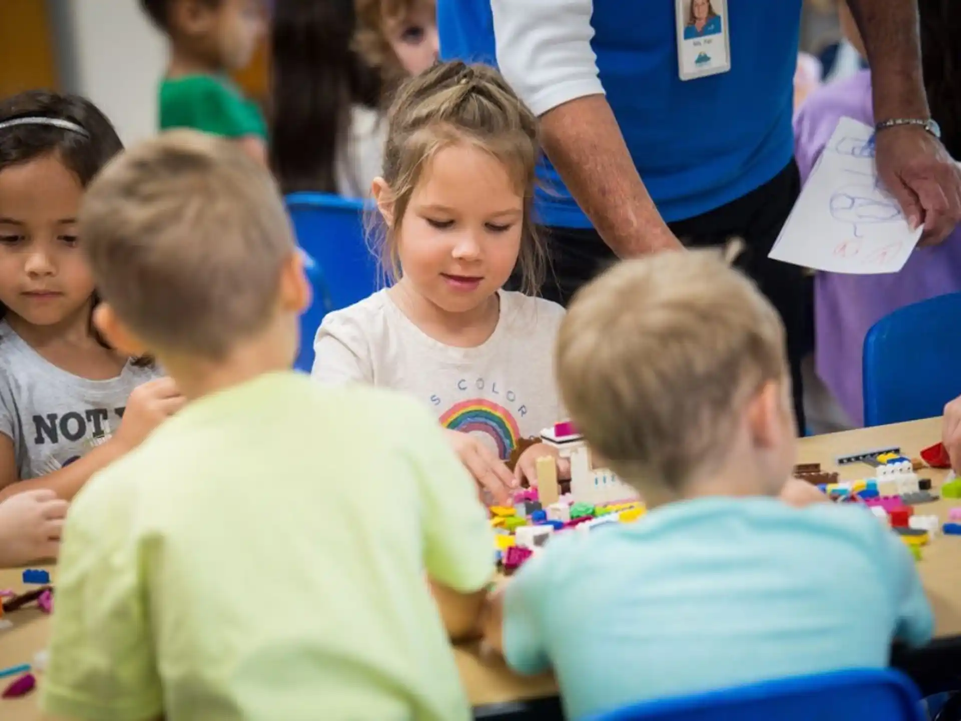 a group of children sitting at a table