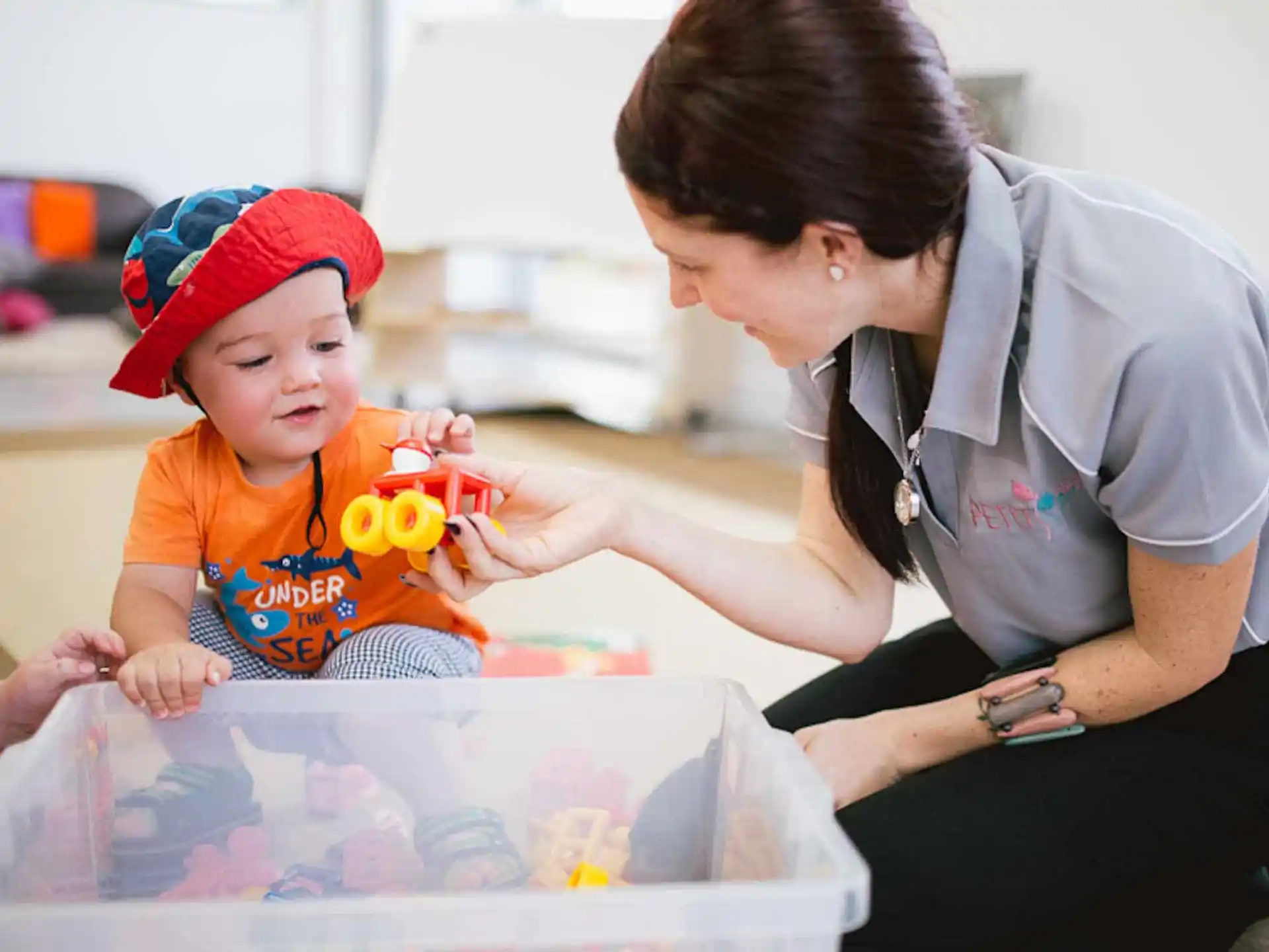 a person and a child playing with toys