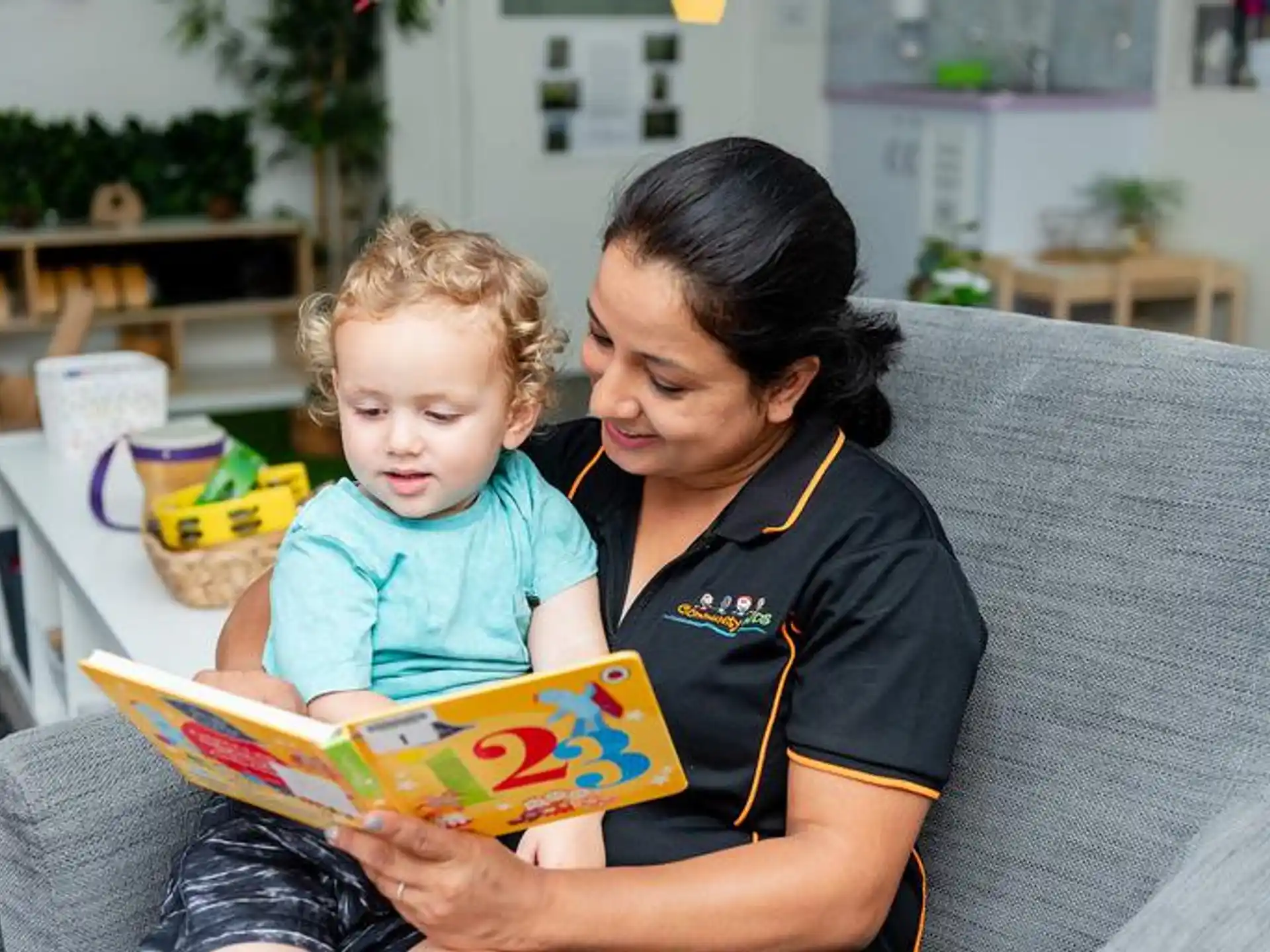 a person reading a book to a child
