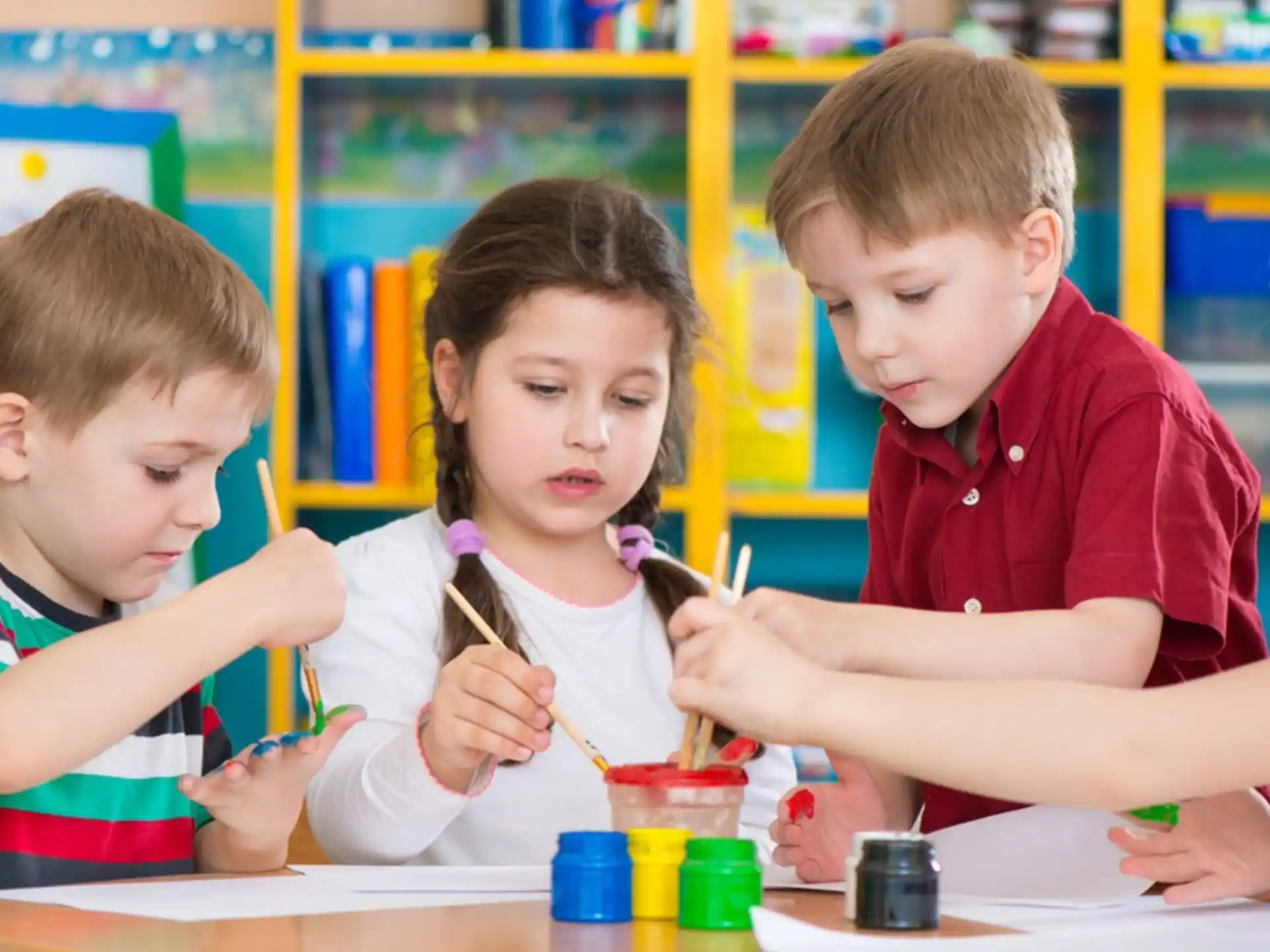 a group of children sitting at a table