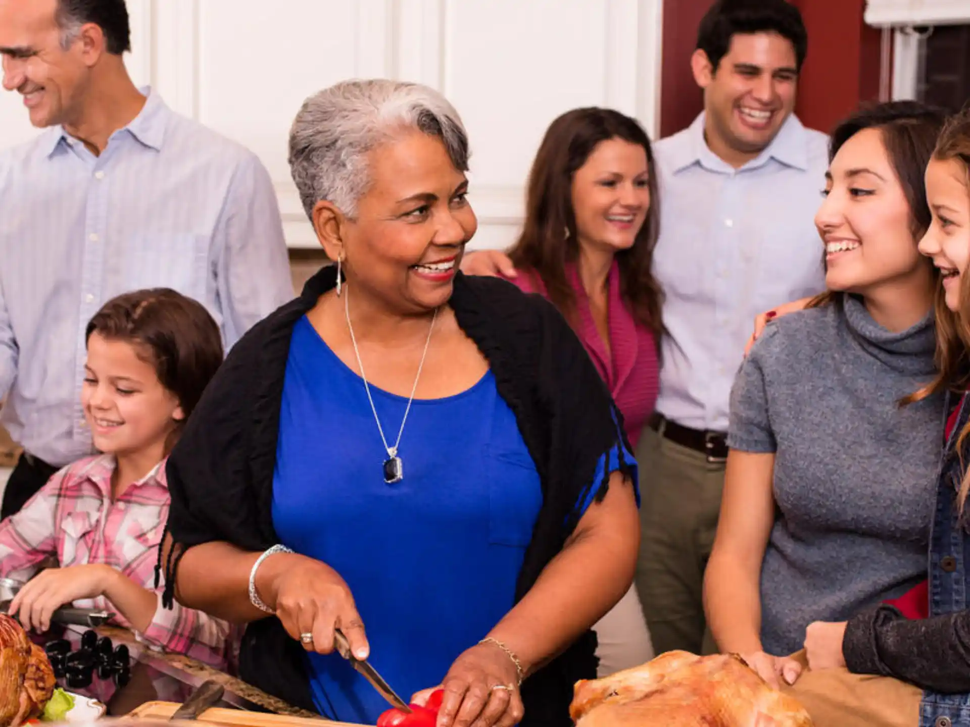 a group of people gathered around a table with food
