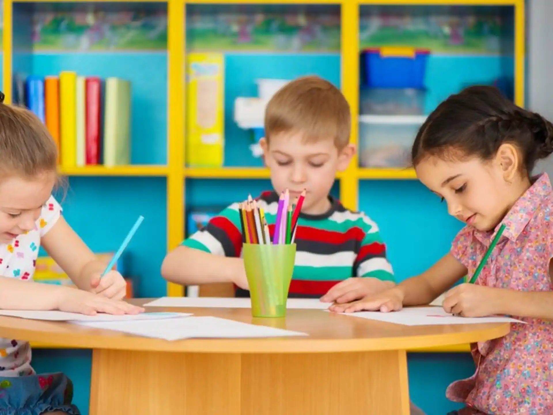 a few children sitting at a table