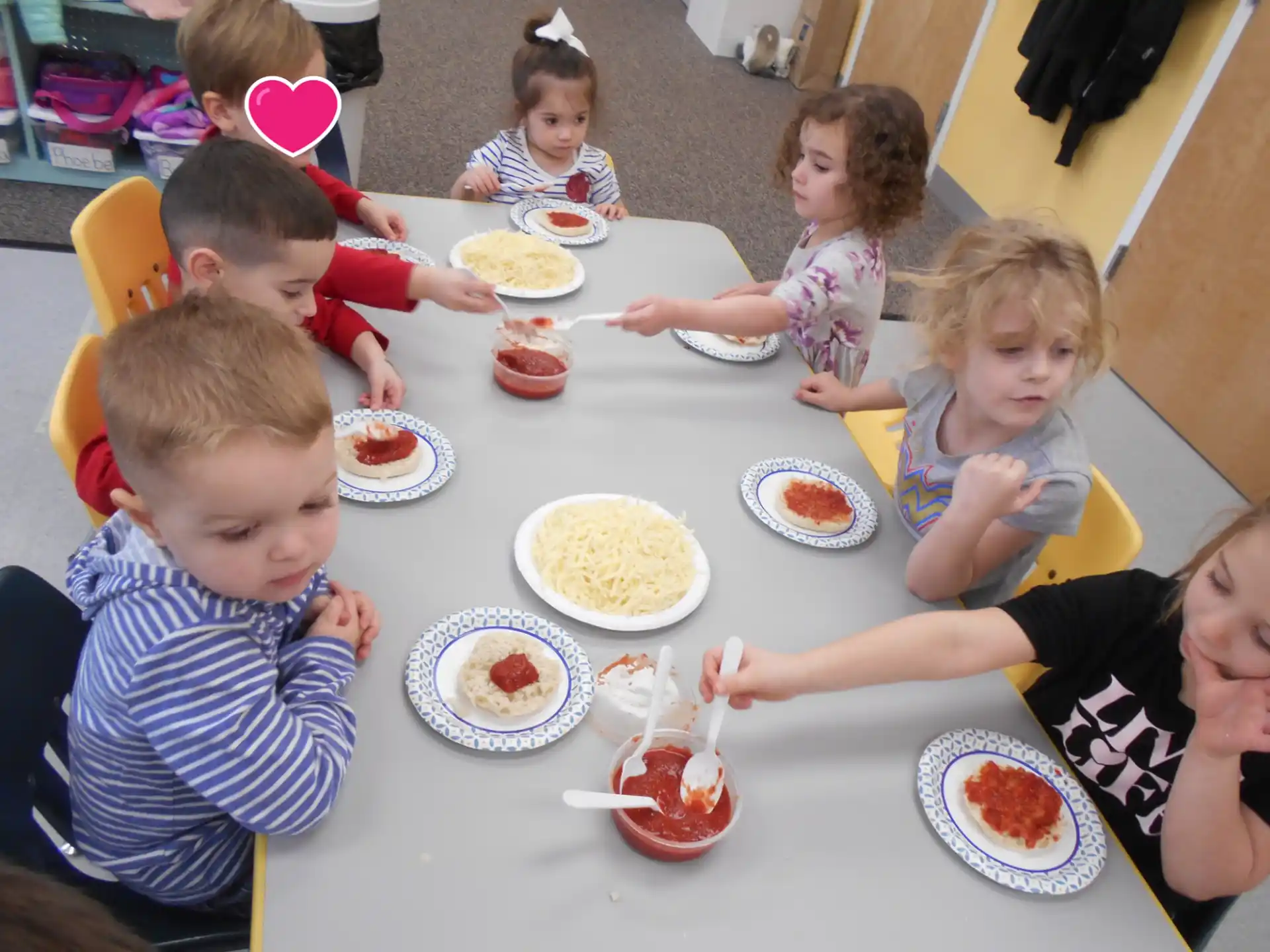 a group of children eating at a table