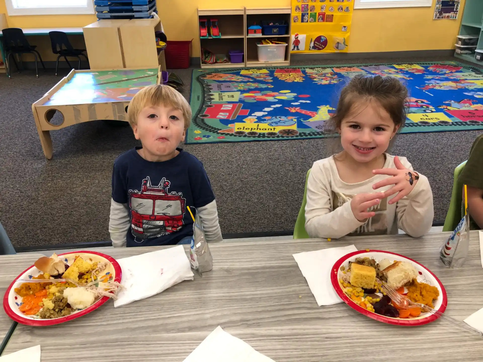 two children sitting at a table