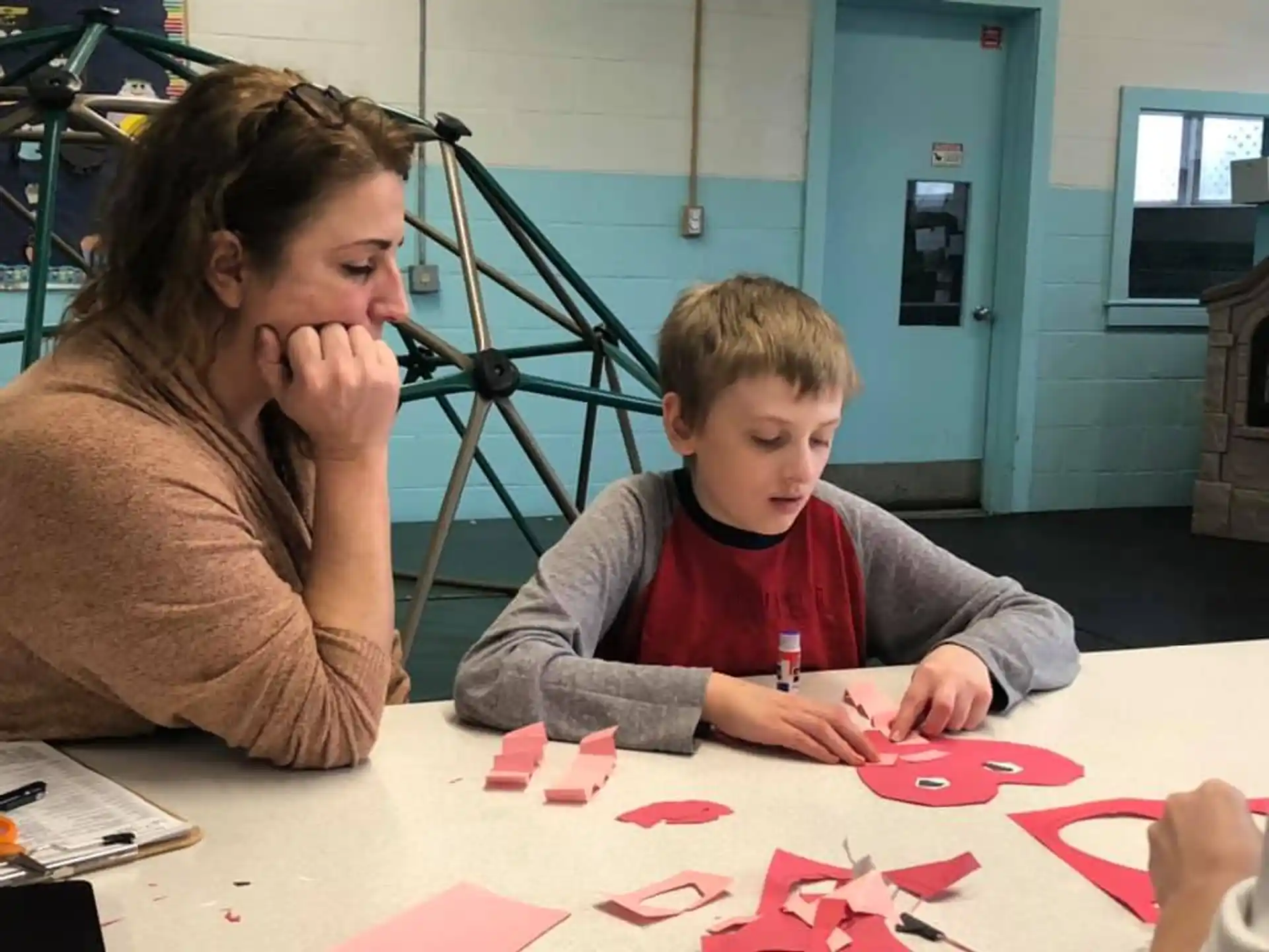 a person and a child playing with cards on a table