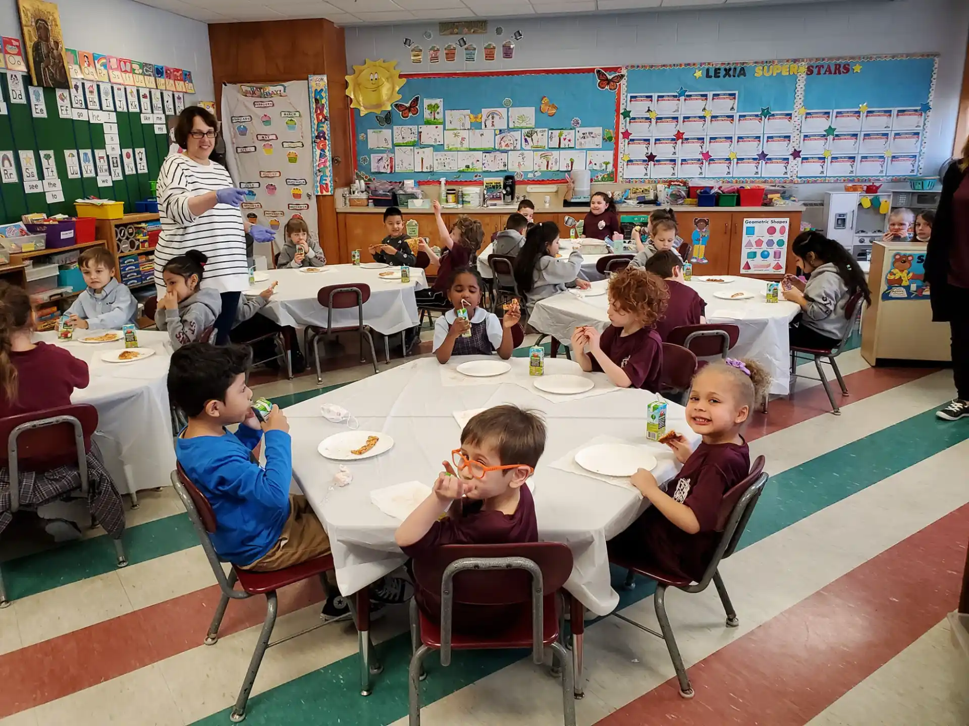a group of children eating at a table