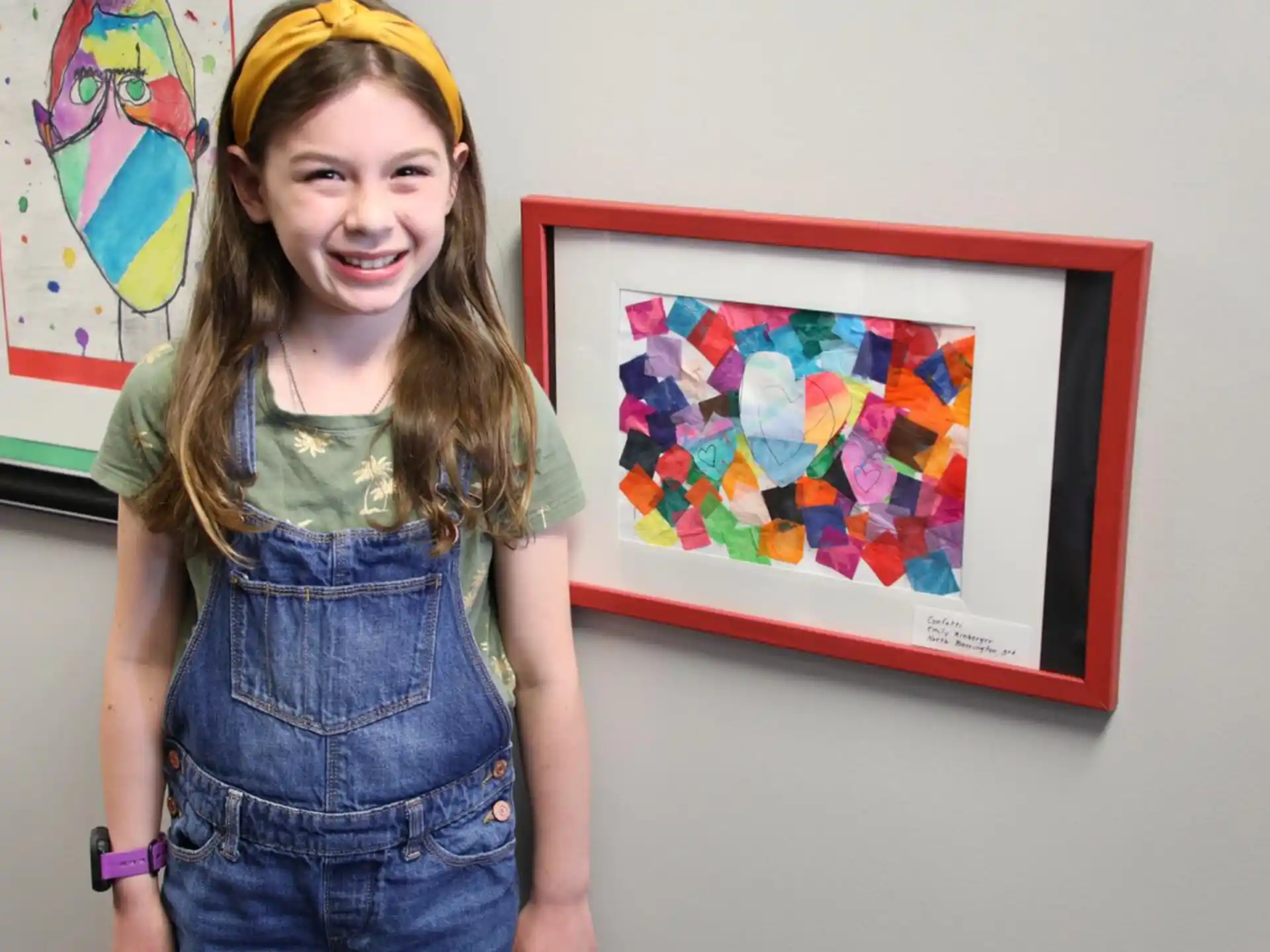 a person standing next to a framed painting