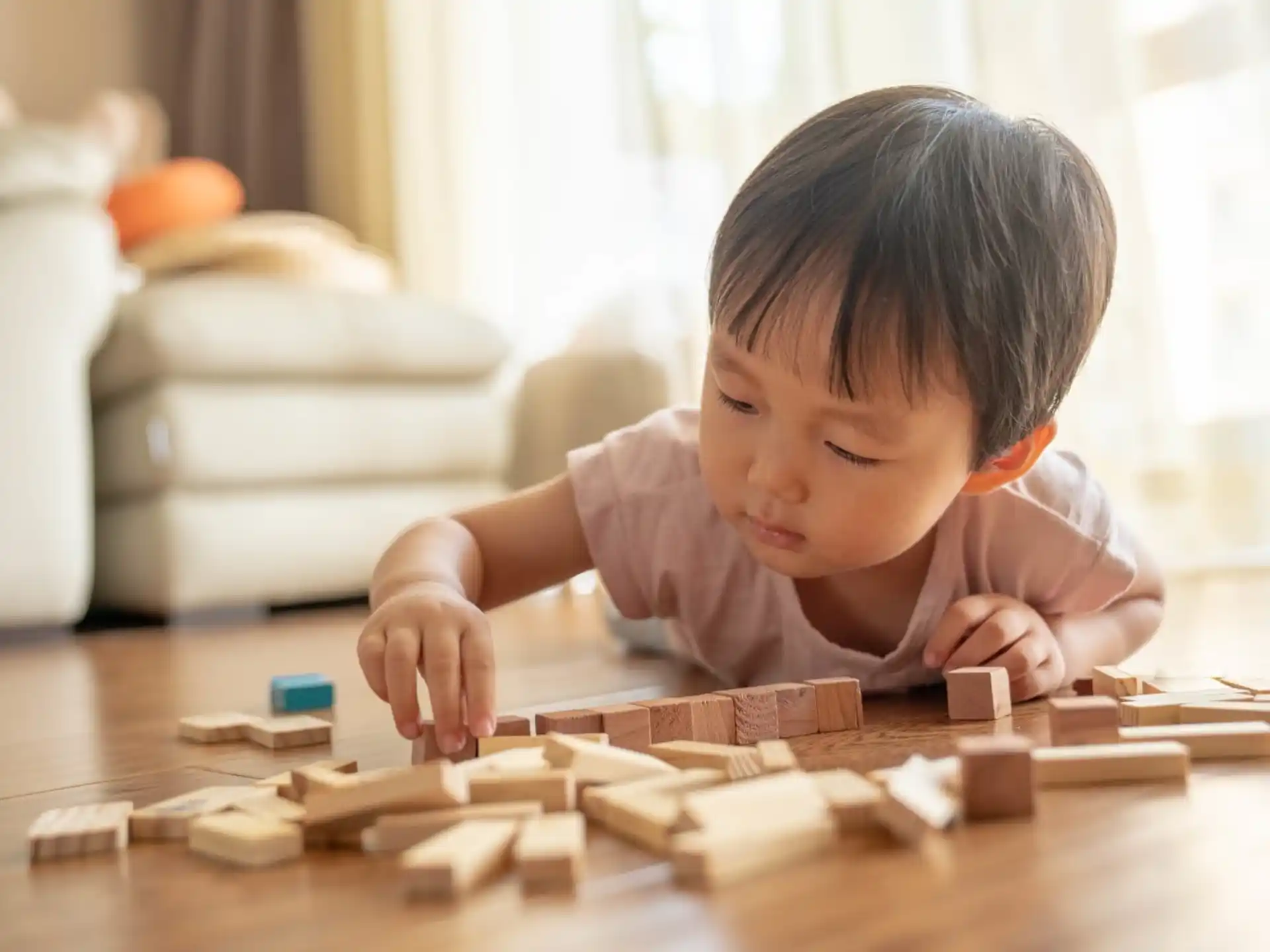 a baby playing with wooden blocks