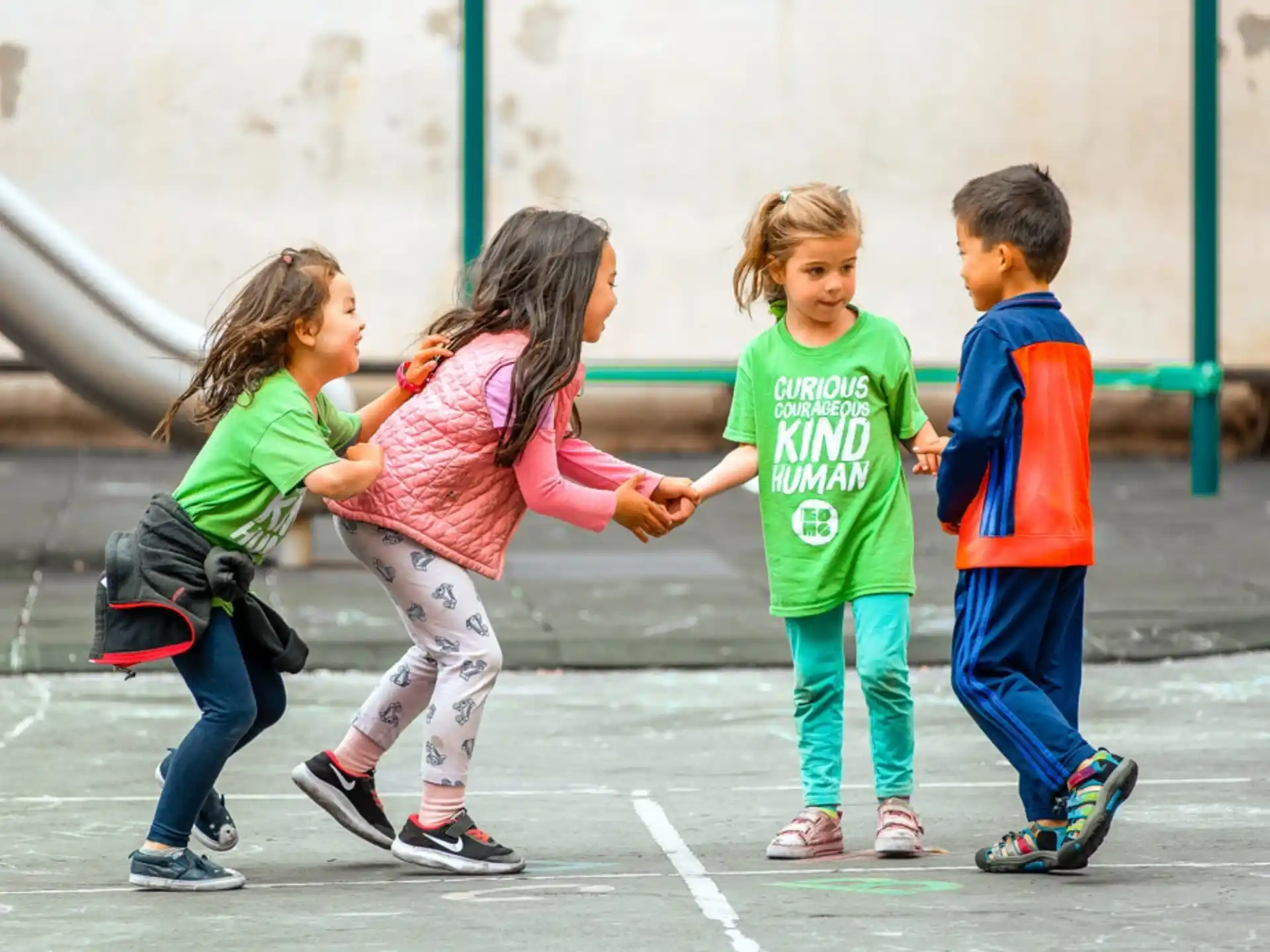 a group of children playing in a parking lot