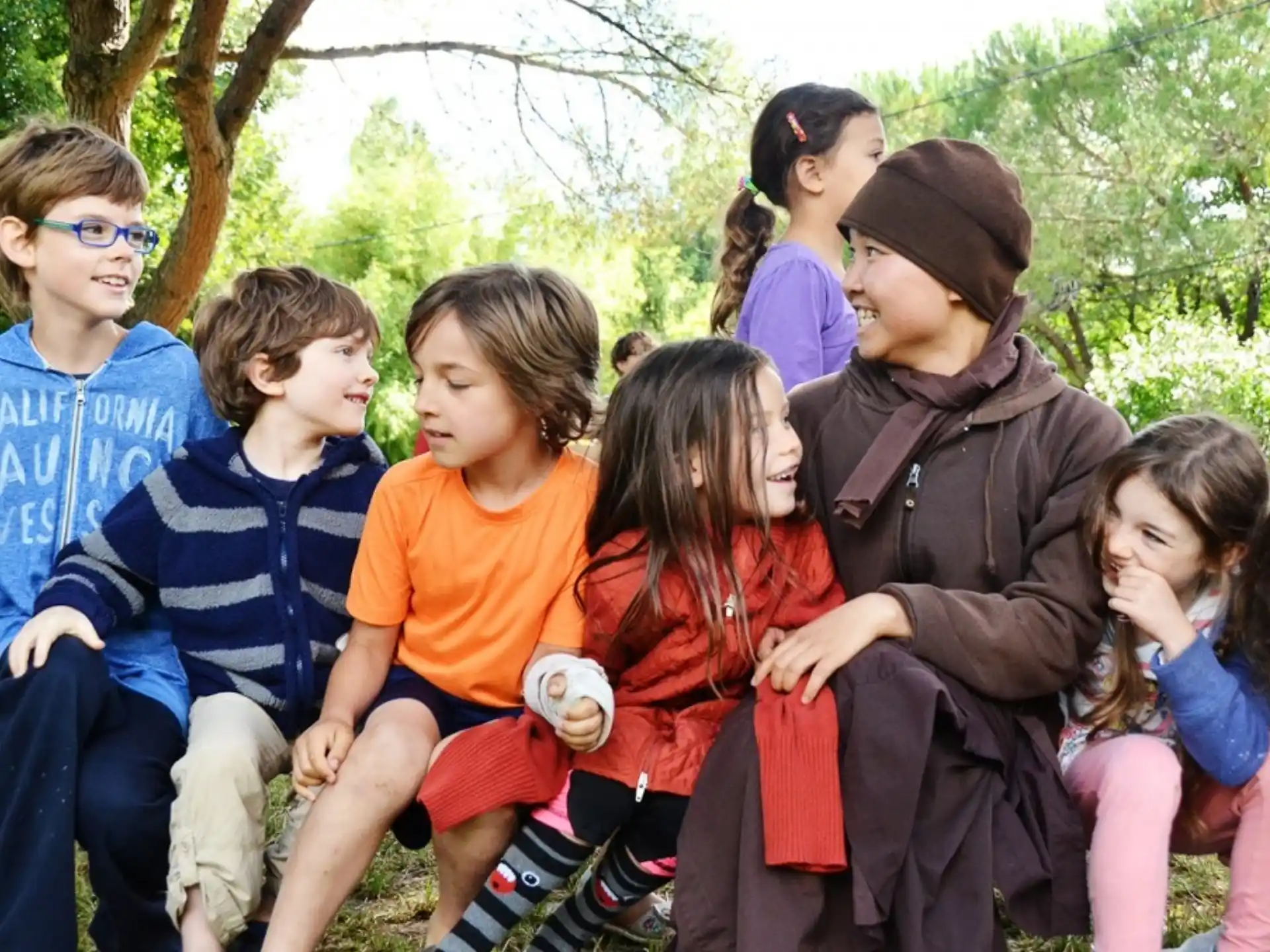 a group of children sitting on a bench