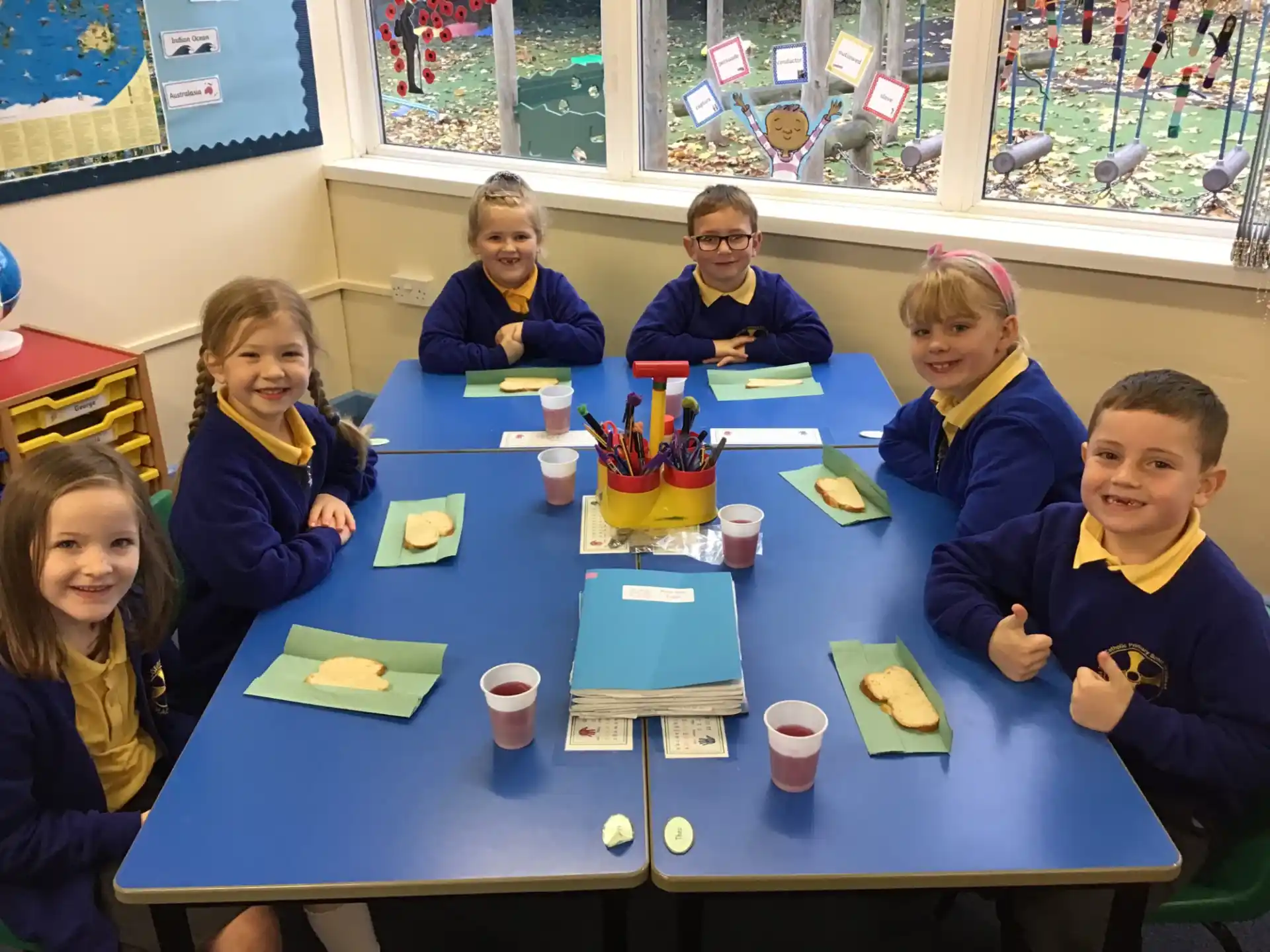 a group of children sitting at a table