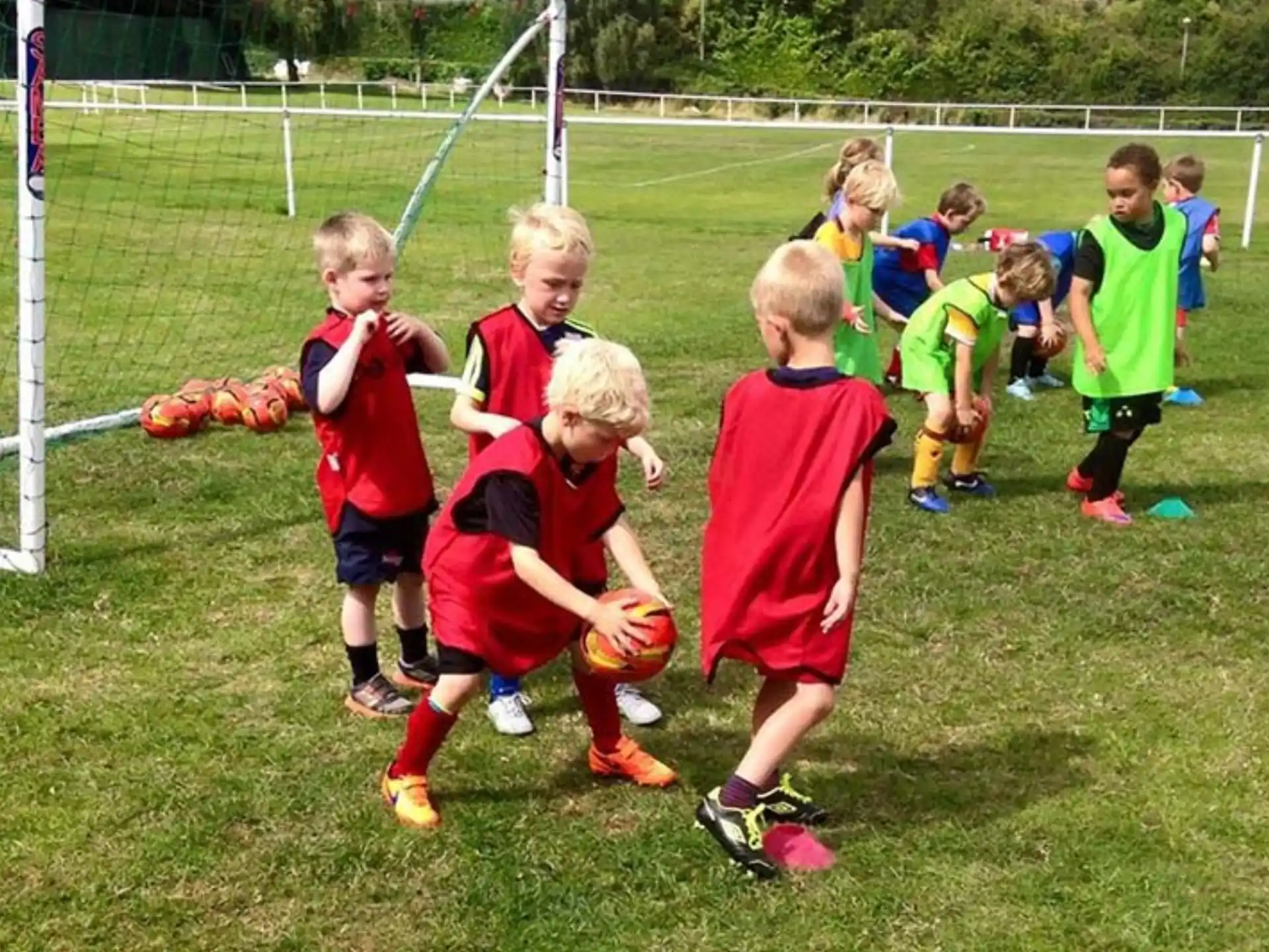 a group of kids playing football