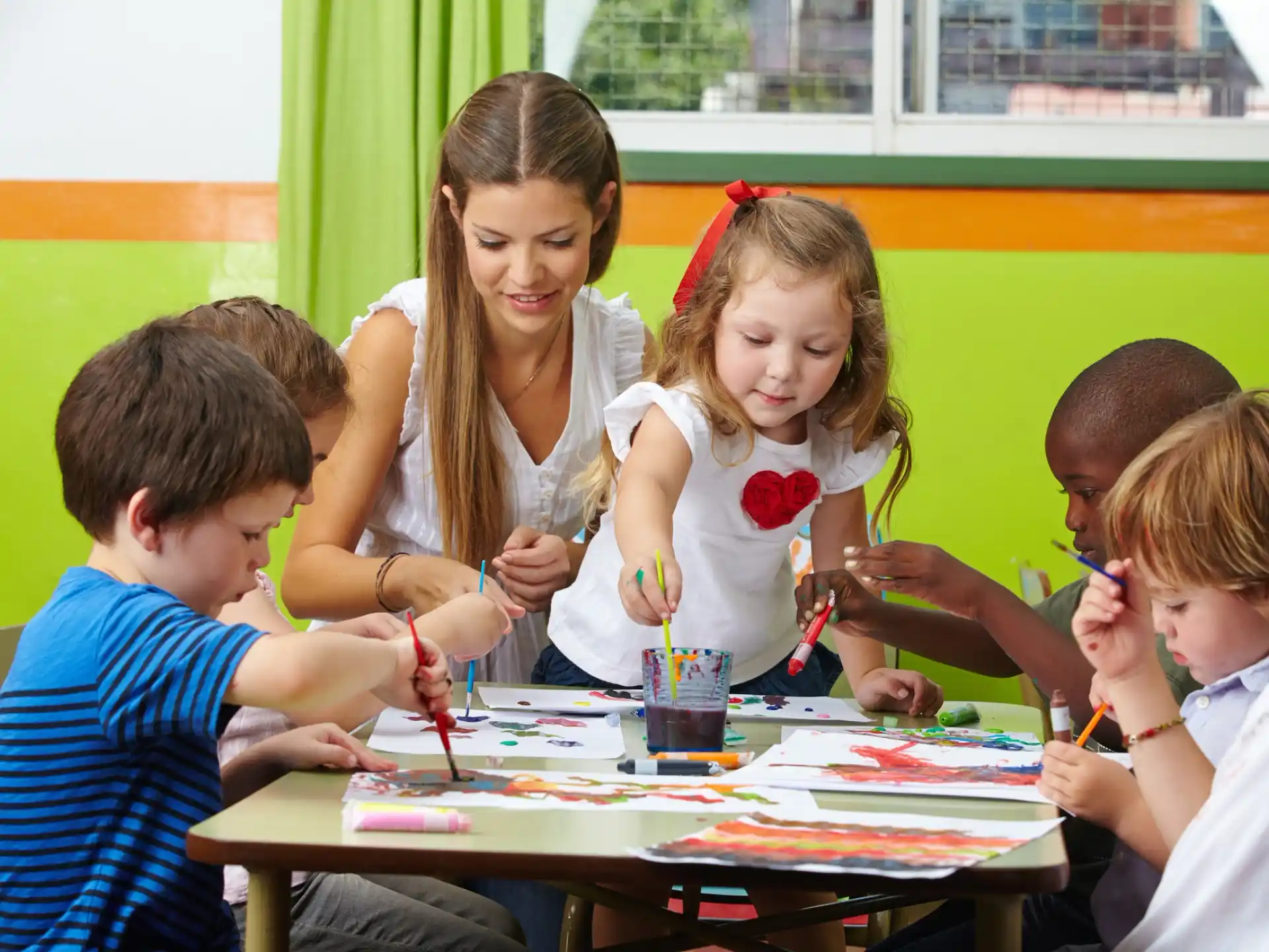 a group of children sitting around a table