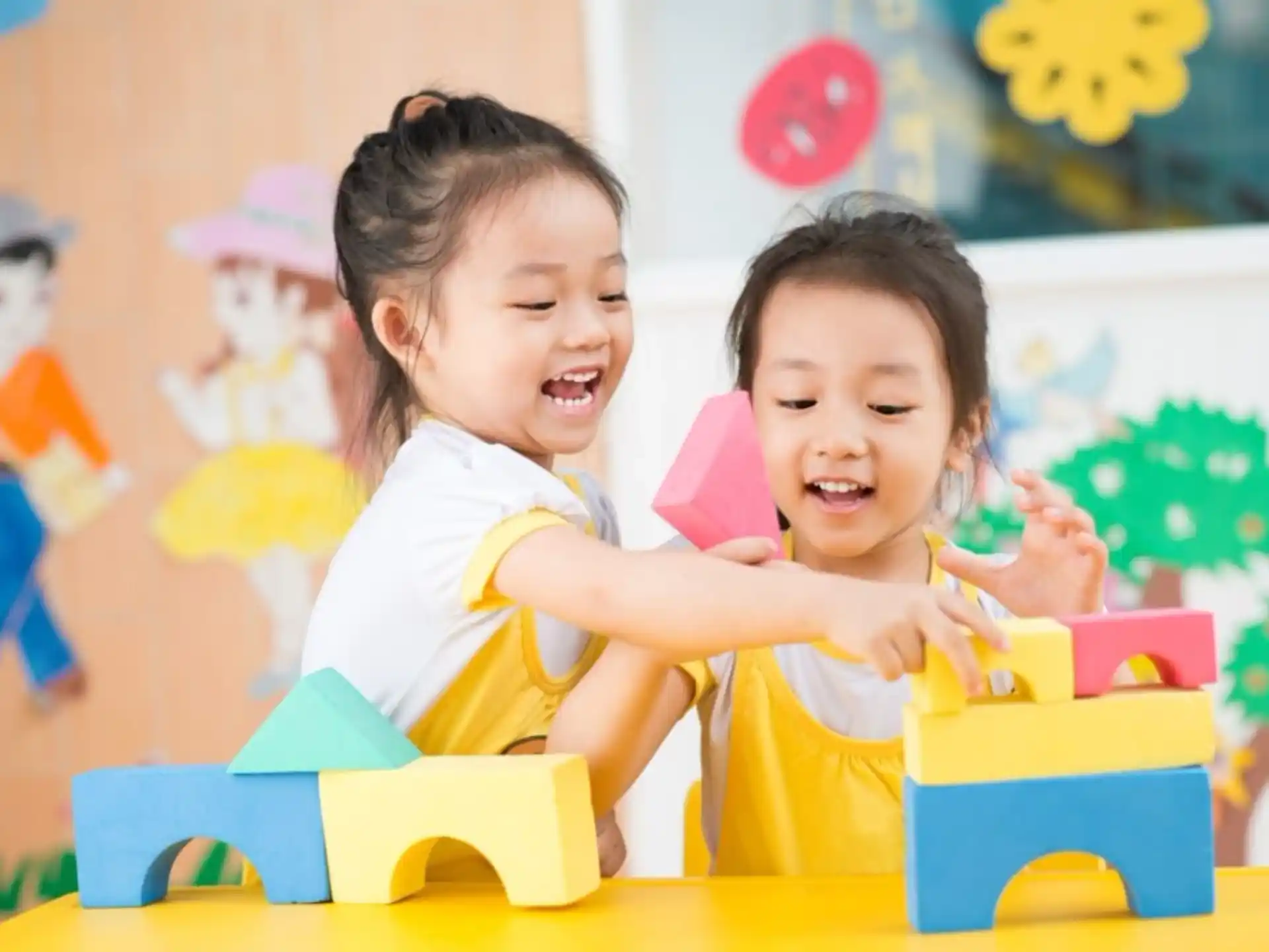 a couple of young girls playing with toys