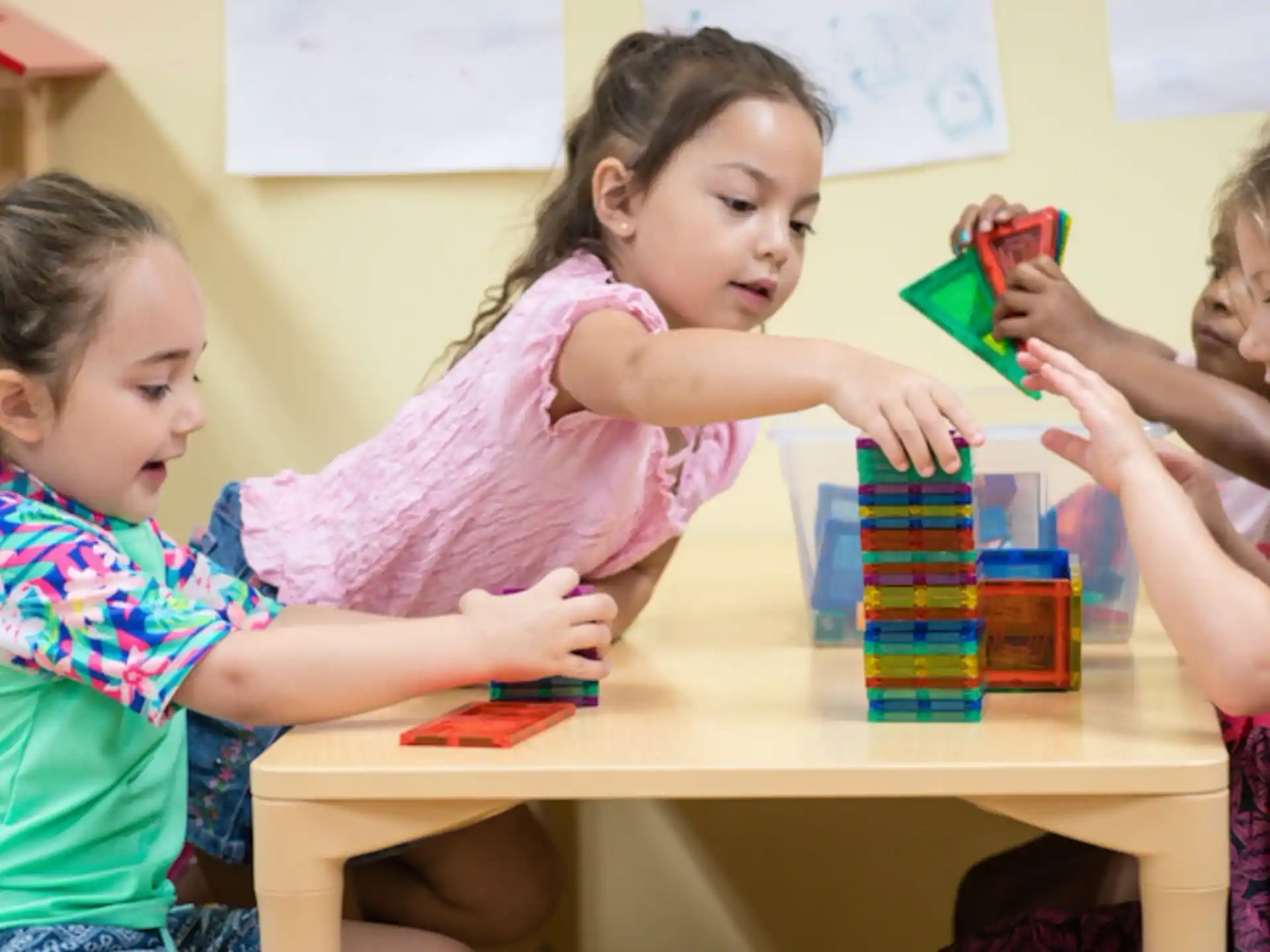 a group of young girls playing with toys
