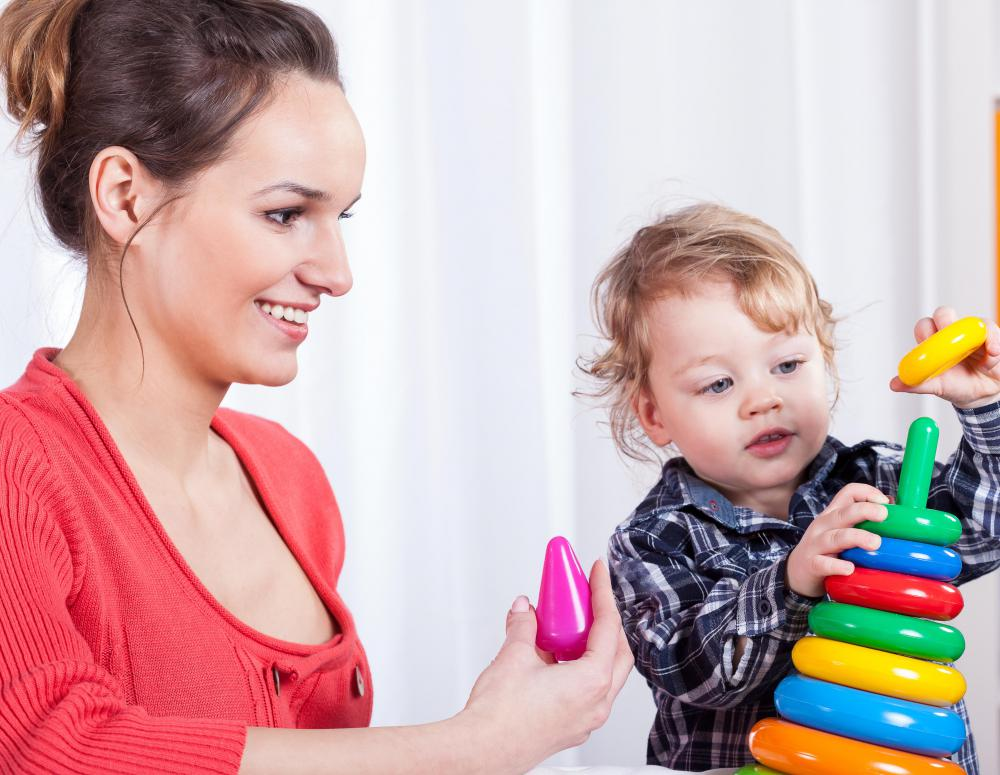 a person and a baby playing with toys