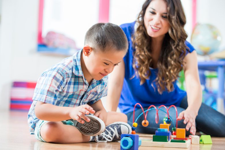 a person and a boy playing with toys
