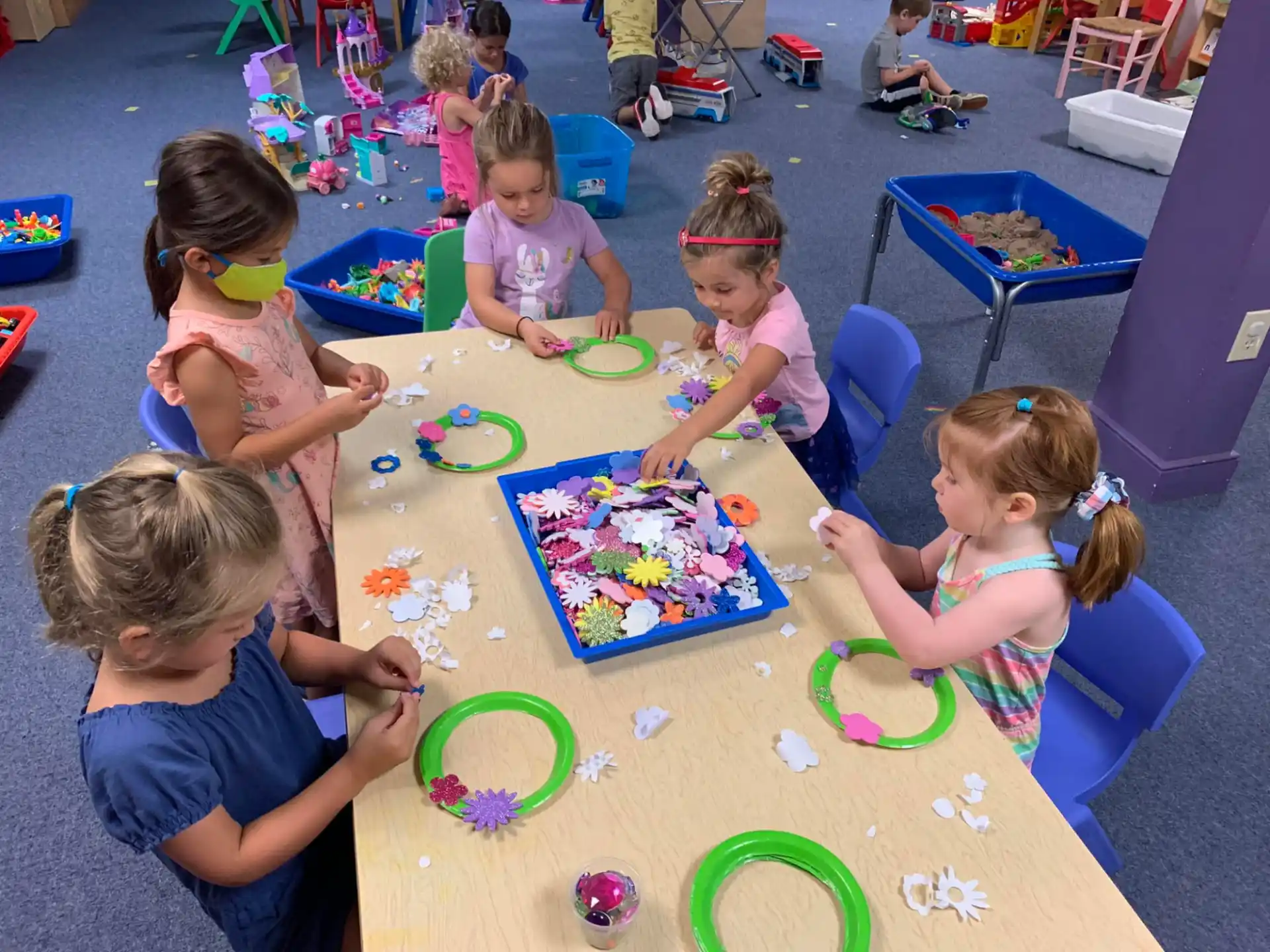 a group of children playing with toys