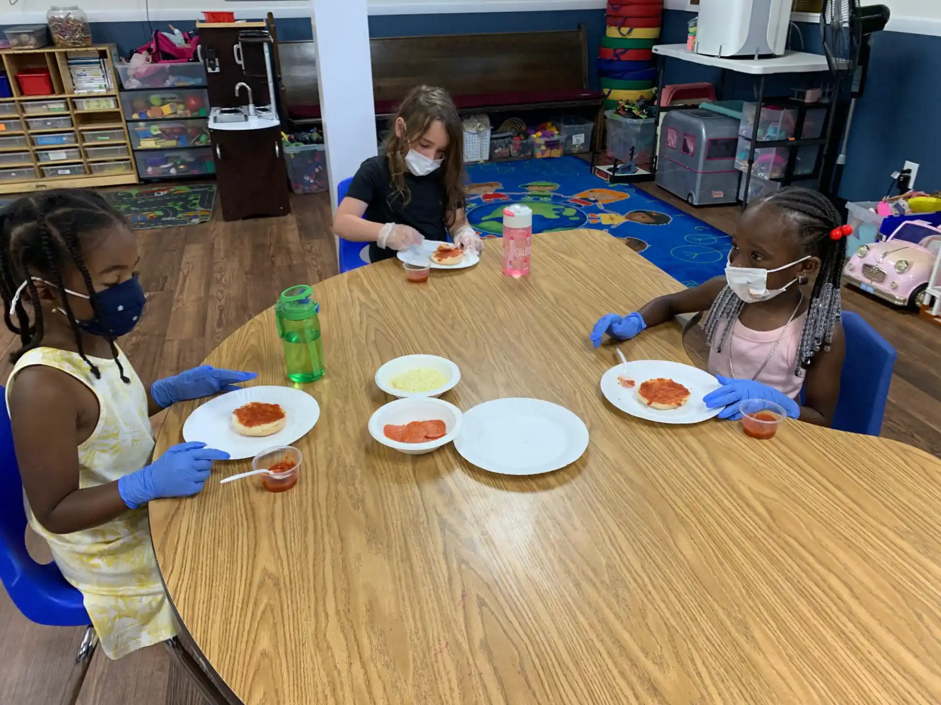 a group of girls eating at a table