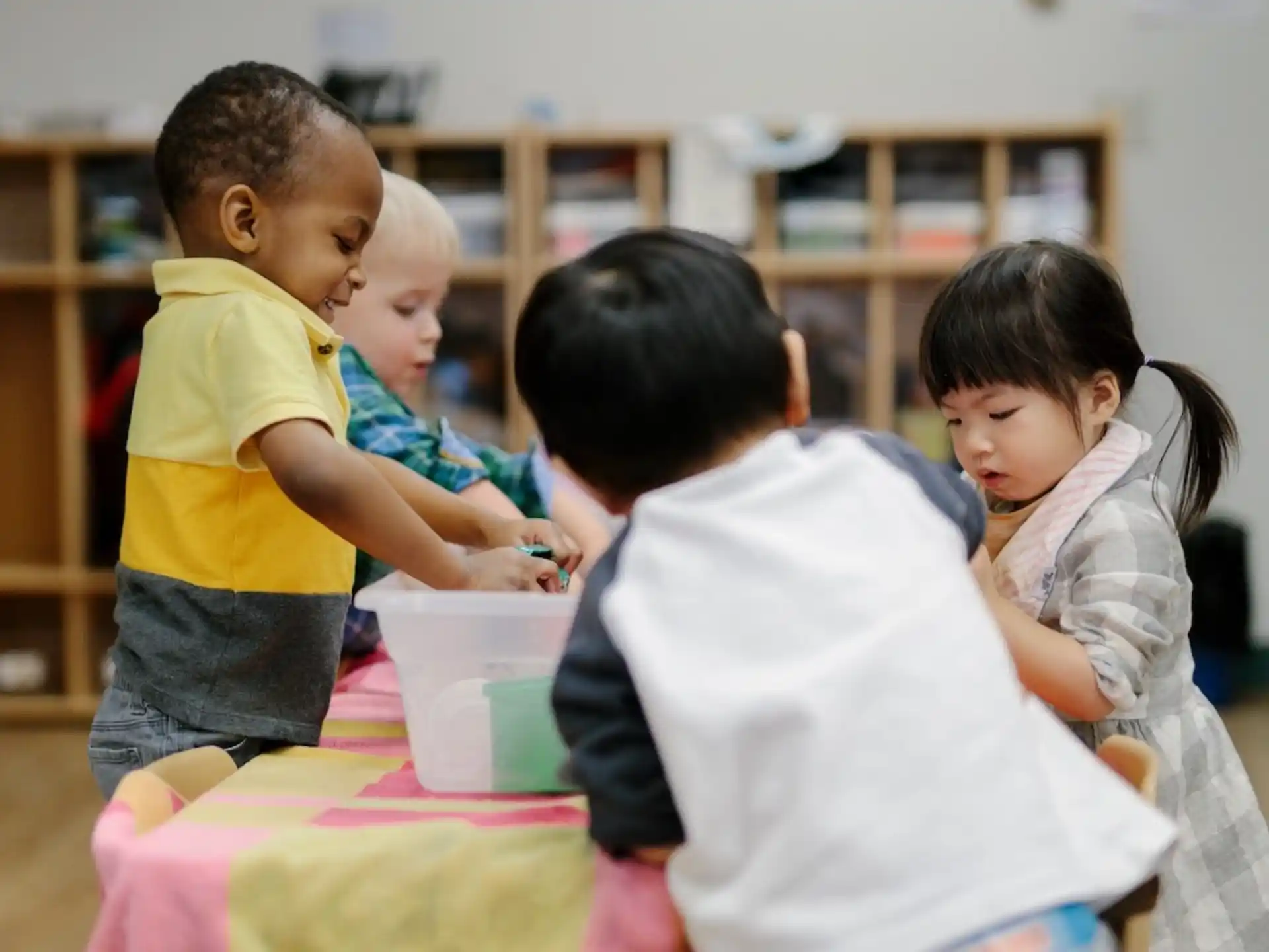 a group of children playing with a toy